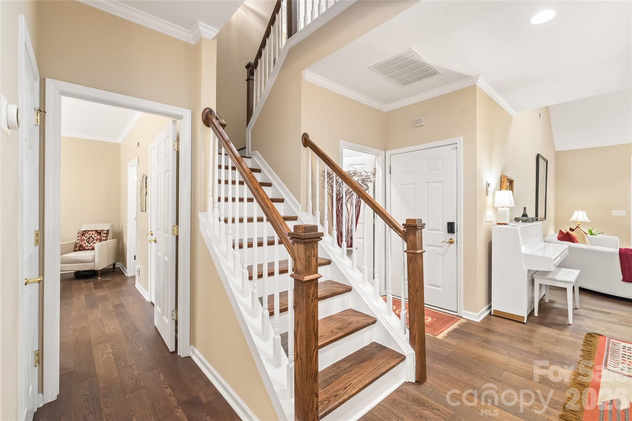 Craftsmanship in every detail! Gorgeous wood stair treads and an updated custom rail bring a sleek, modern touch. - 4780 Grier Farm Lane, Charlotte