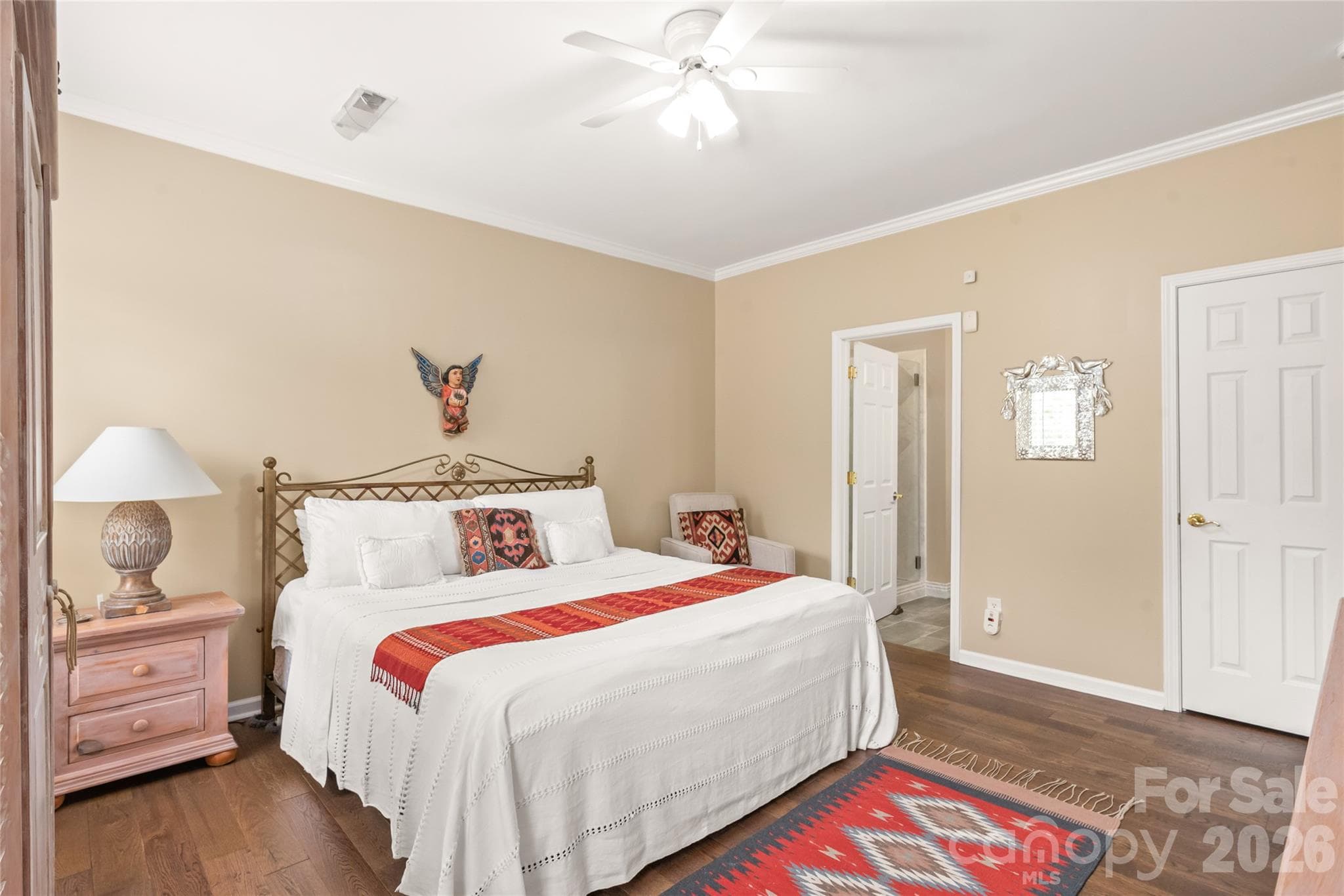 The primary suite features a spacious walk-in closet and a beautifully updated bathroom complete with quartz countertops and a custom stone-tile shower. - 4780 Grier Farm Lane, Charlotte