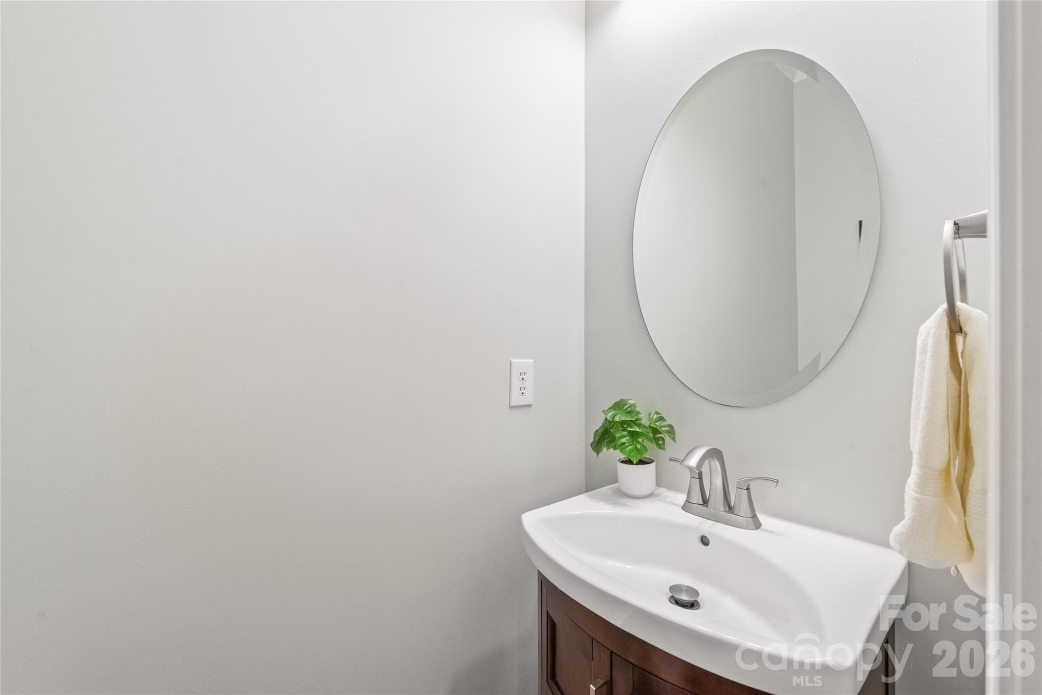 The main-level powder room features a fresh, updated vanity with built-in storage—the perfect stylish touch for guests and daily convenience. - 4780 Grier Farm Lane, Charlotte