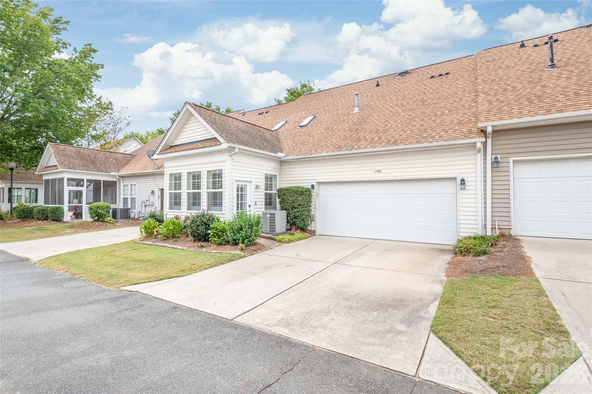 Tucked neatly around back, the rear-load two-car garage offers clean curb appeal from the street, easy driveway access, and custom built-in shelving for extra storage. - 4780 Grier Farm Lane, Charlotte