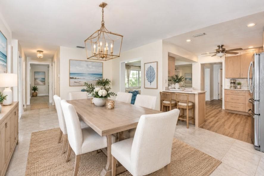 Virtually staged dining room connected to kitchen - 5230 VENETIAN BLVD NE, ST PETERSBURG