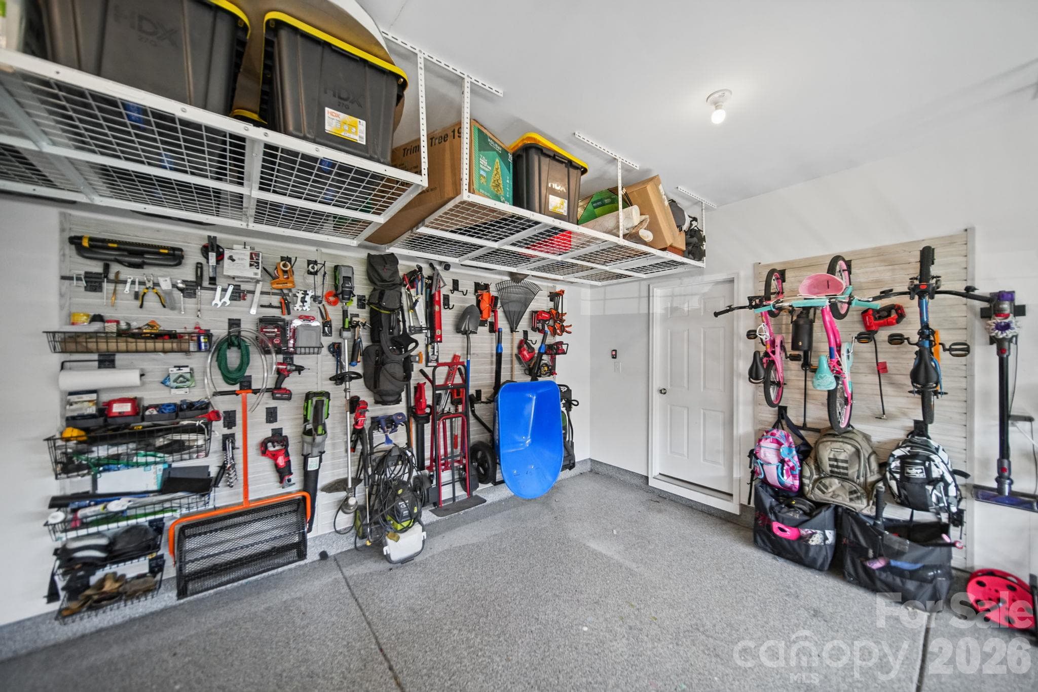 Garage with customizable storage and epoxy floor. - 1112 Alyssa Oaks Drive, Lowell