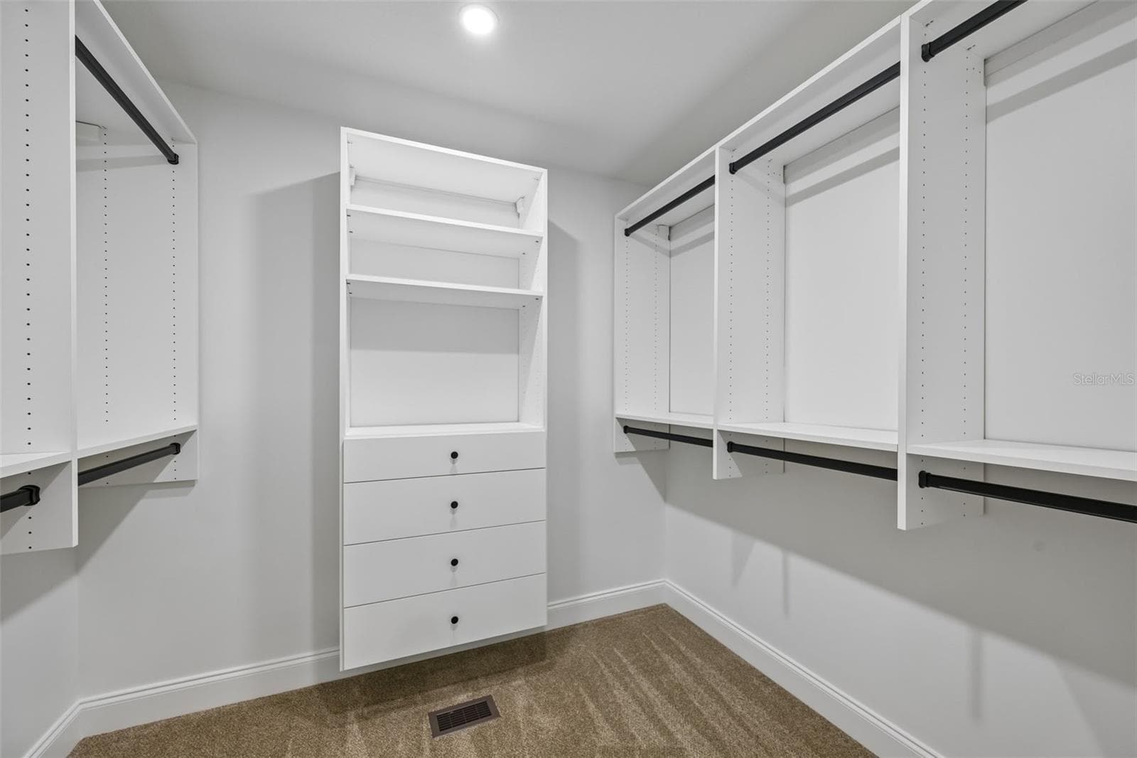 2nd Large walking in closet with California Closet system in the primary suite. - 5060 18TH AVE W, BRADENTON