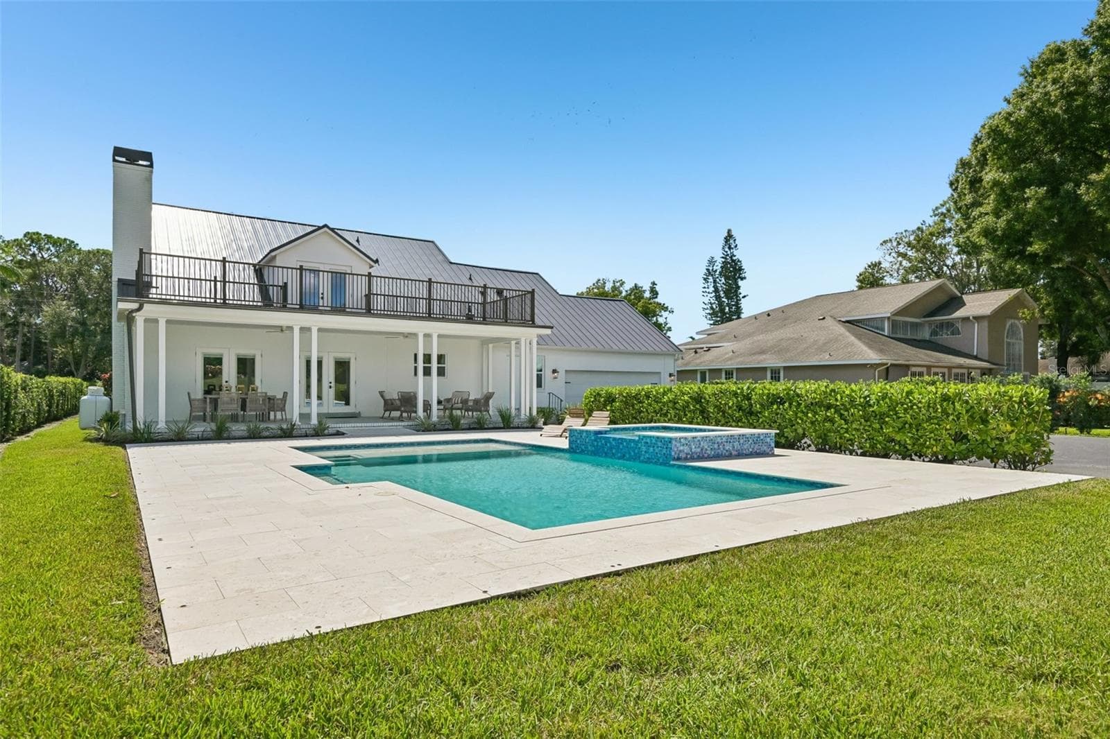 This home features a large, heated saltwater pool and spa. - 5060 18TH AVE W, BRADENTON
