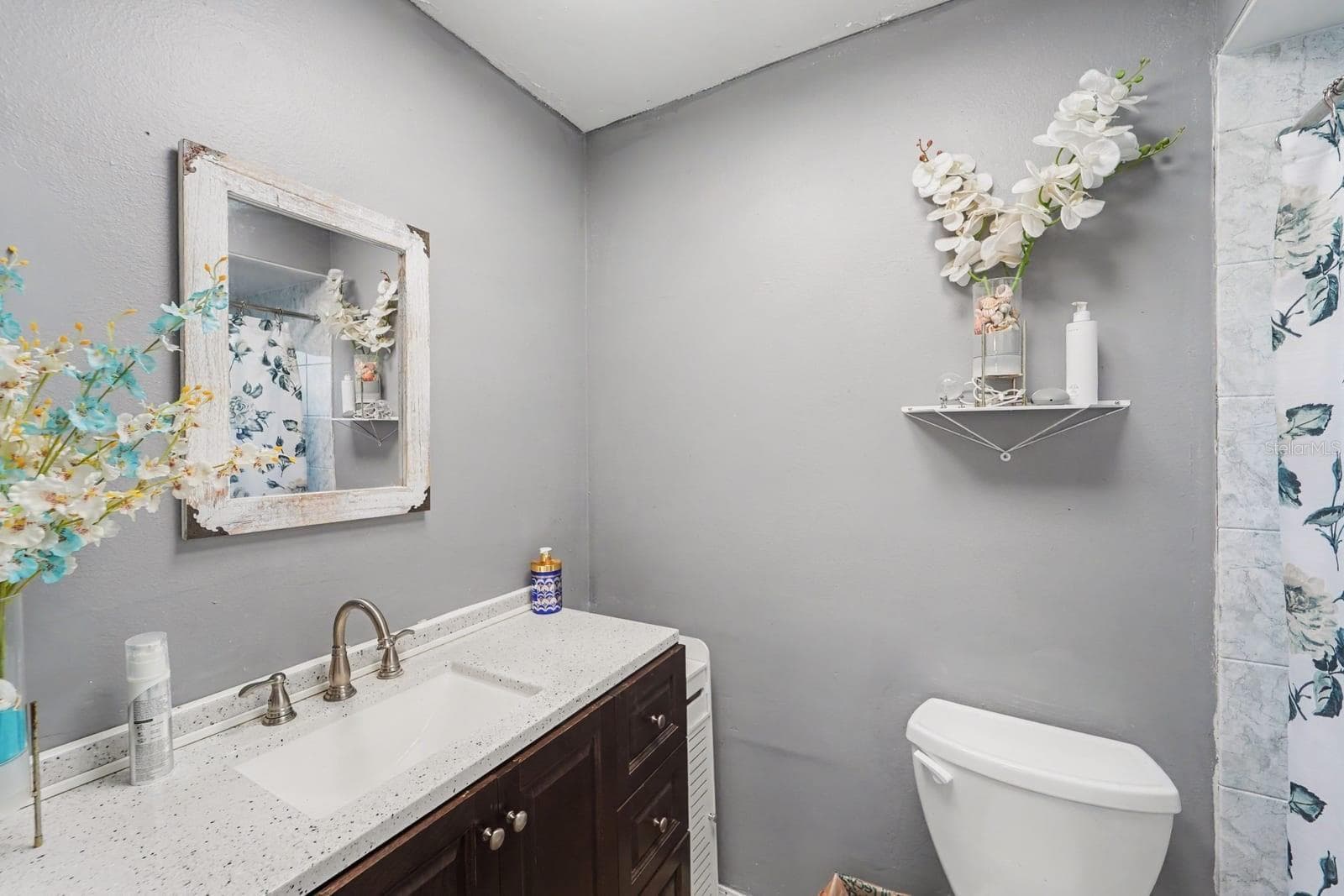 Spa-Like Half Bath With Marble Vanity, Wallpaper & Elegant Finishes - 8431 REDFIELD DR, PORT RICHEY