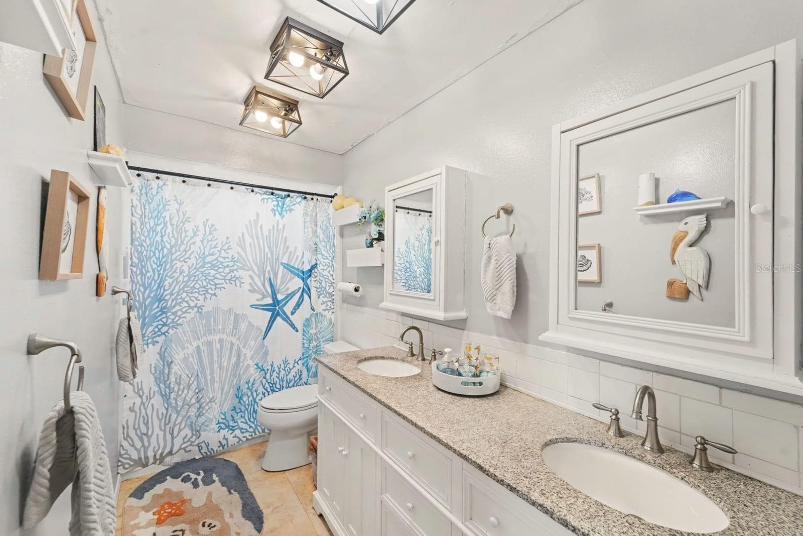 Master Bath with Dual Vanity, Coastal Décor & Framed Mirror Medicine Cabinet - 8431 REDFIELD DR, PORT RICHEY