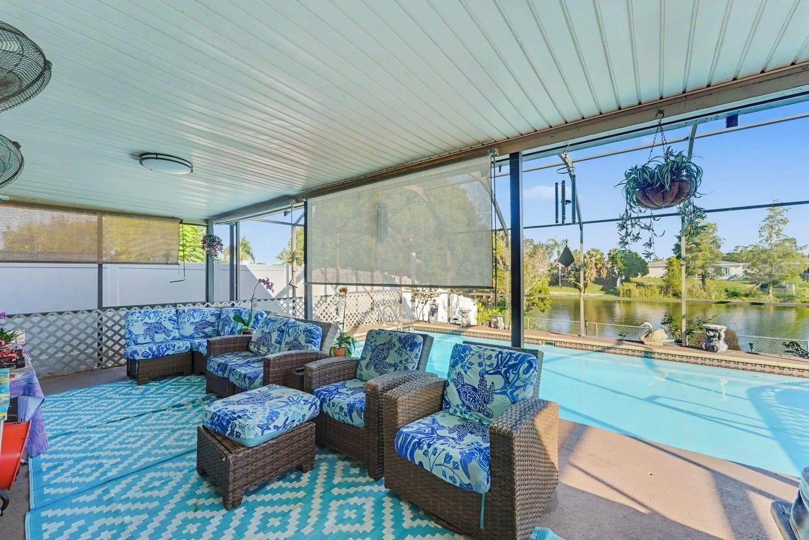 Screened Pool Lanai Overlooking Water, Wicker Seating & Blue & White Furnishings - 8431 REDFIELD DR, PORT RICHEY