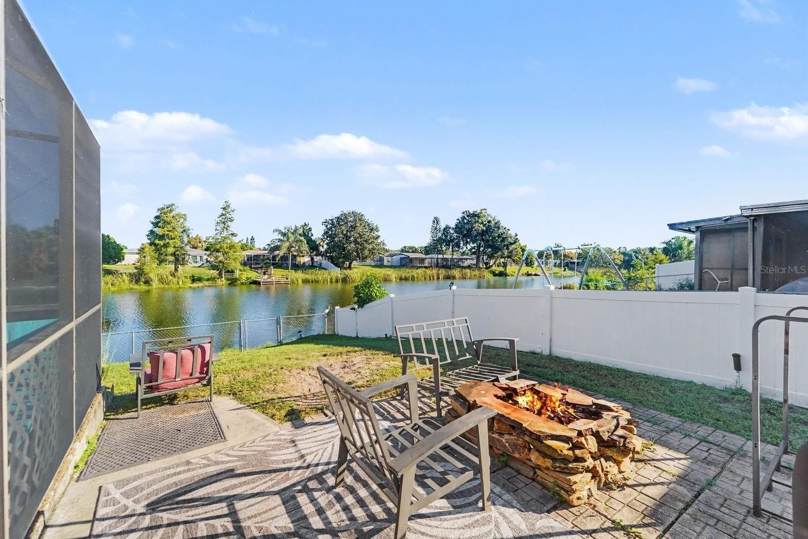Waterfront Patio with Fire Pit & Lounge Seating Overlooking the Water - 8431 REDFIELD DR, PORT RICHEY