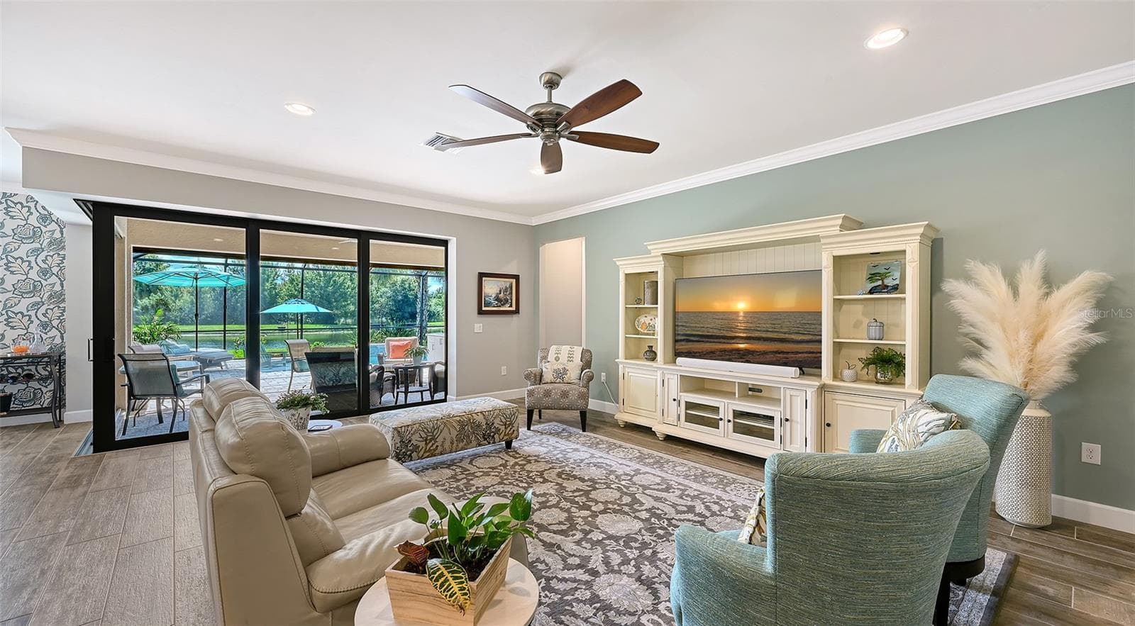 This inviting great room provides the perfect setting to unwind, relax, and enjoy the comfort of this exceptional home. - 6827 GOSPORT CV, BRADENTON