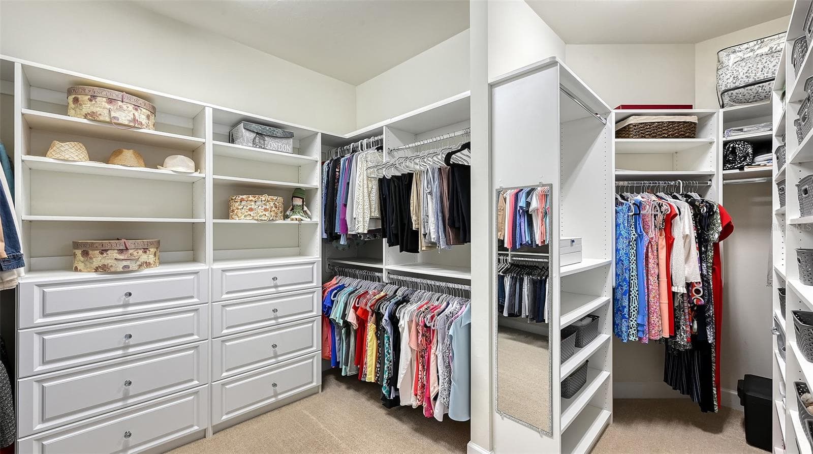 Primary closet with custom built-ins with an abundant amount of space for true luxury living. - 6827 GOSPORT CV, BRADENTON