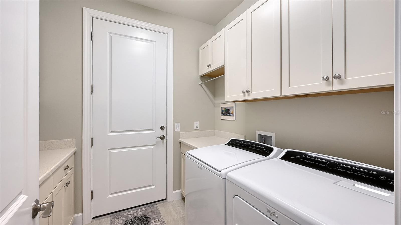 This exceptional laundry room has built-in cabinets on both side of the room for additional storage for your convenience. - 6827 GOSPORT CV, BRADENTON
