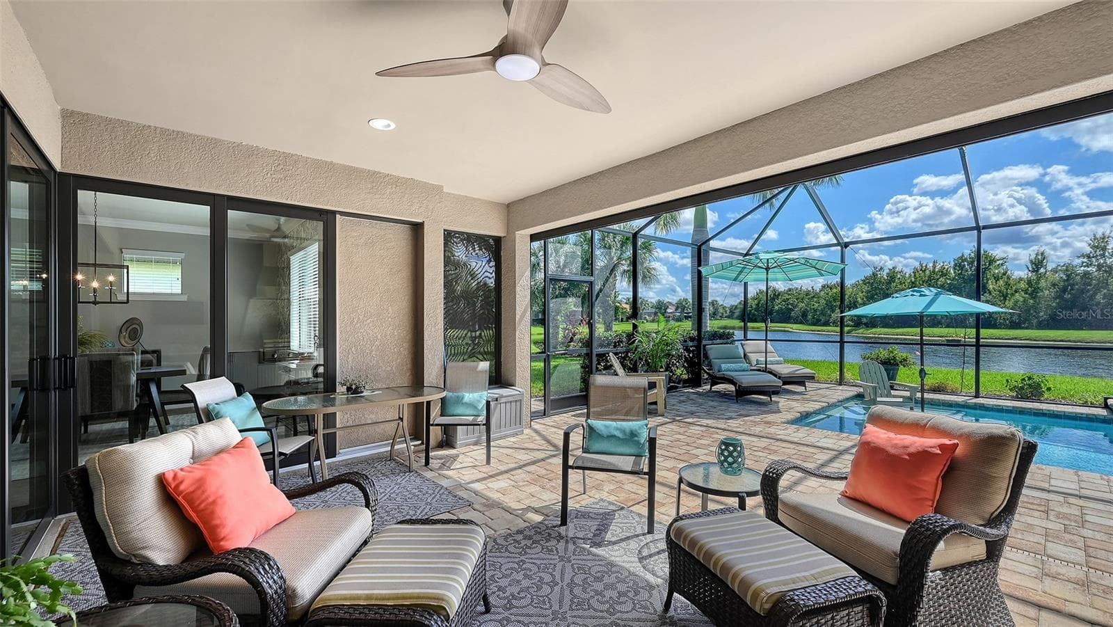 Step into your own outdoor oasis, where covered seating, a well-appointed outdoor kitchen, and breathtaking views create the perfect backdrop for Florida living. - 6827 GOSPORT CV, BRADENTON