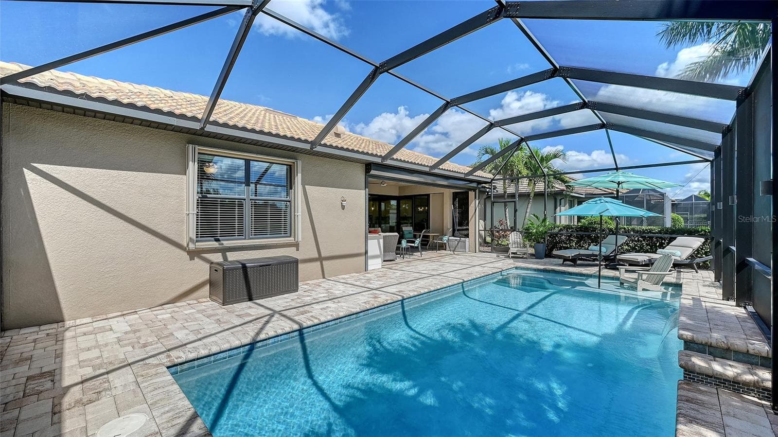 Enjoy leisurely afternoons lounging beneath the covered lanai. - 6827 GOSPORT CV, BRADENTON