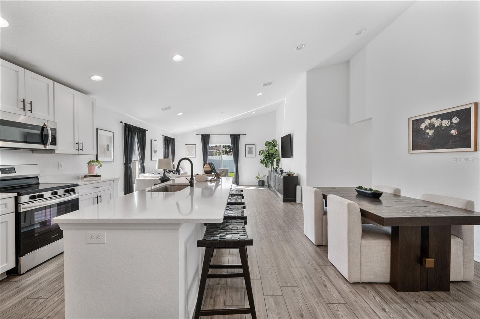 The kitchen & dining room are light & bright. Luxury vinyl plank flooring flow seamlessly throughout this entire home. - 1279 PINTAIL PL, LAKELAND