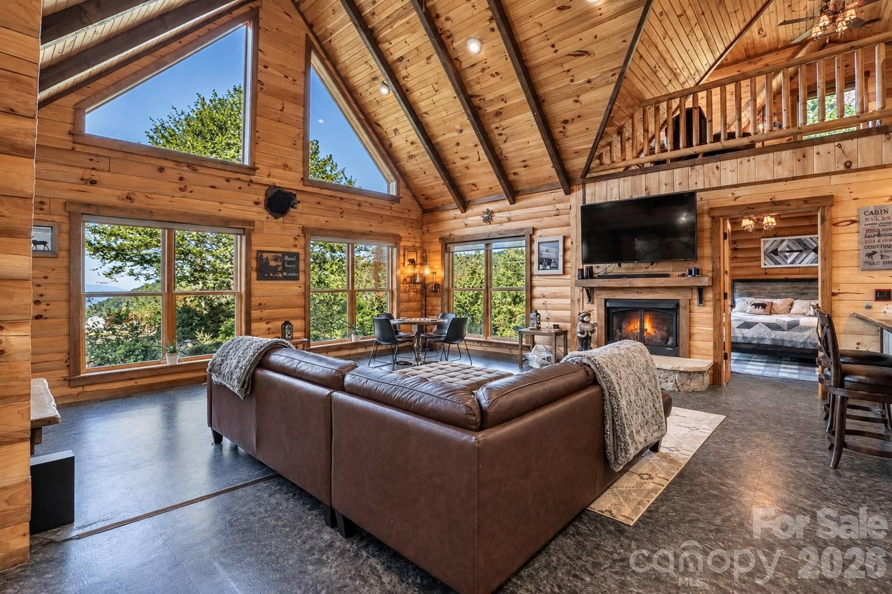 Great room with vaulted ceiling, gable windows and fireplace - 18 Fairway Run, Bryson City