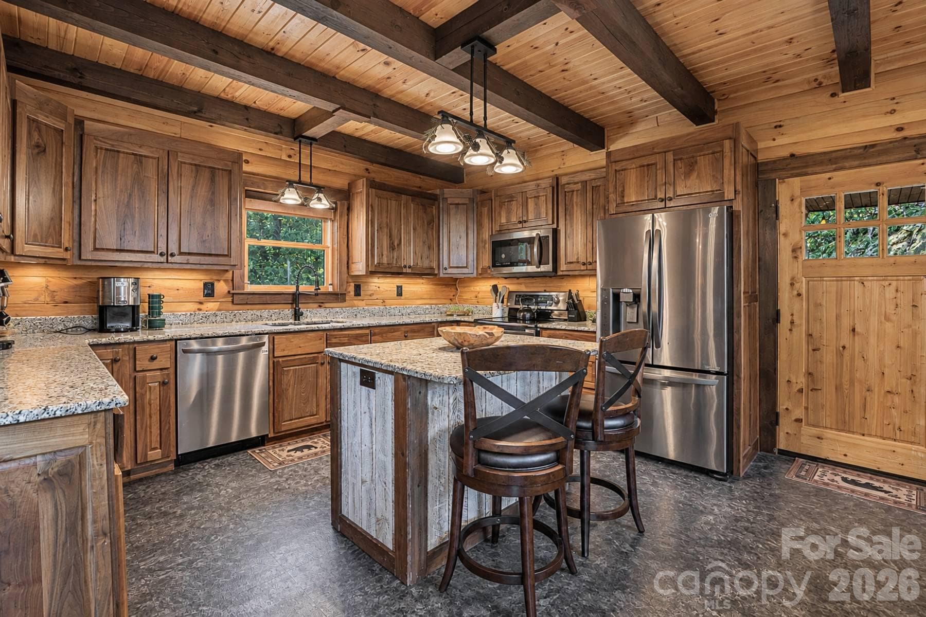 Kitchen with island seating, granite and stainless appliances - 18 Fairway Run, Bryson City