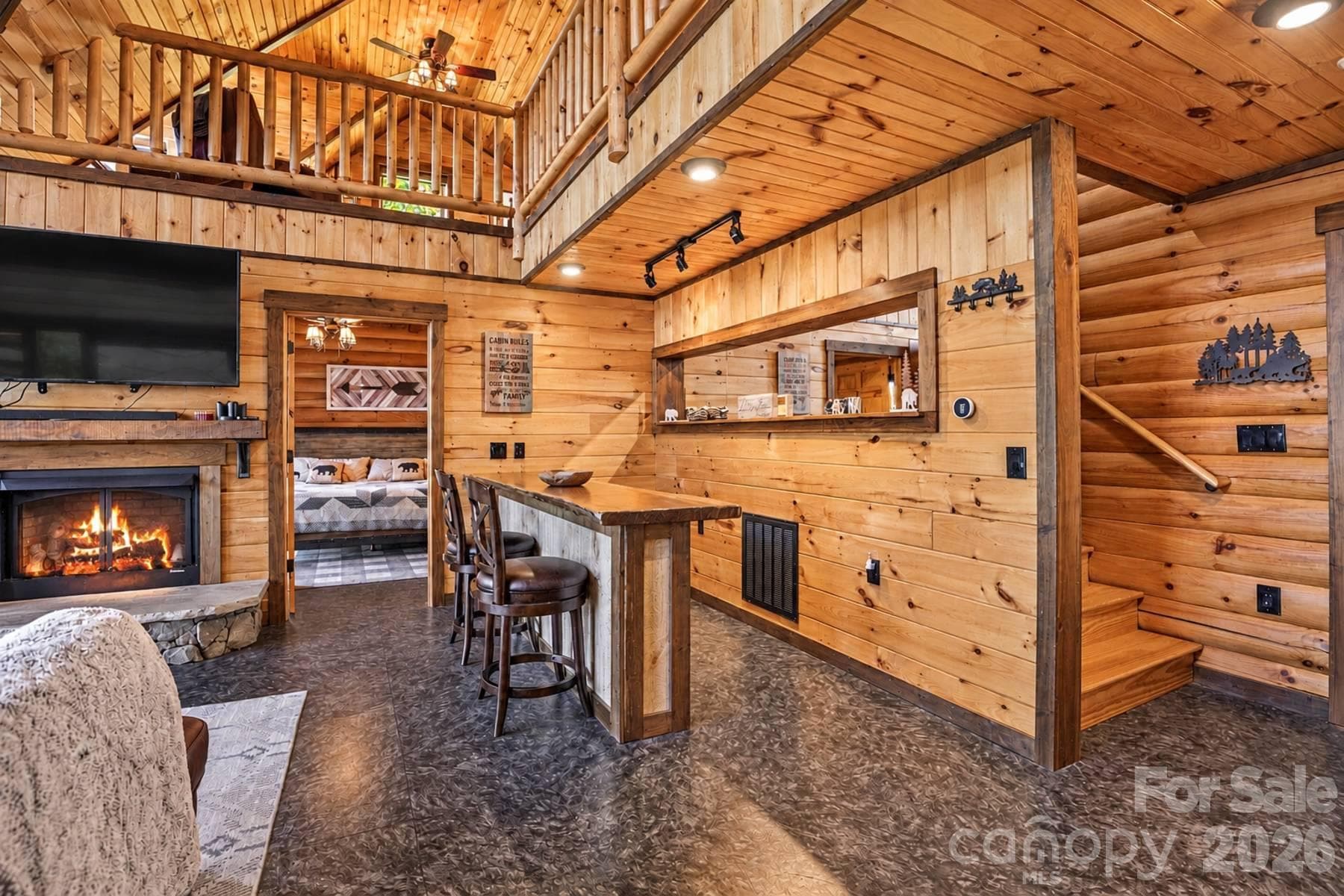 Bar, fireplace and stairs to the upper level - 18 Fairway Run, Bryson City