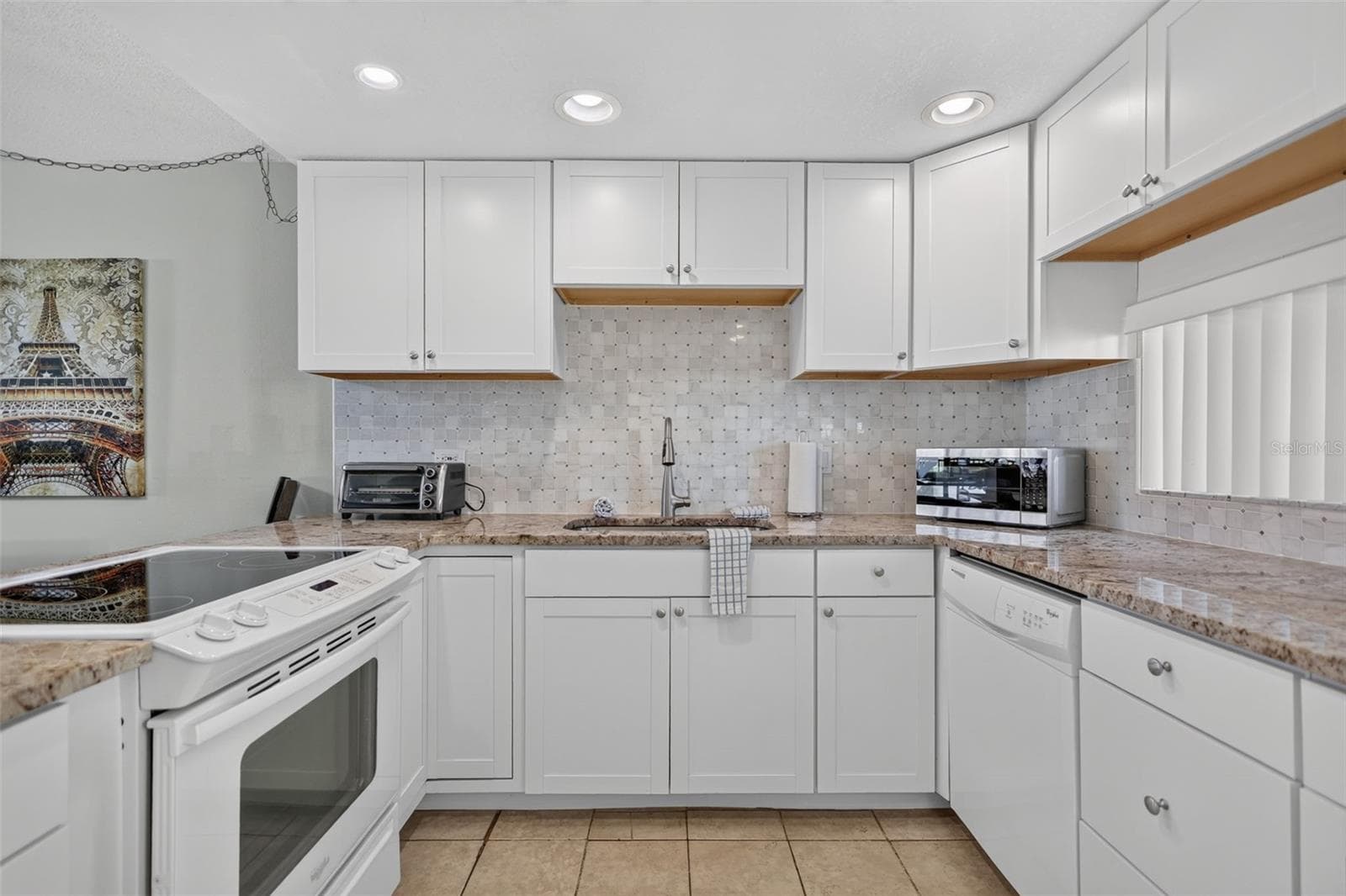 Spacious kitchen featuring an abundance of cabinet storage. - 6157 MIDNIGHT PASS RD #E53, SARASOTA