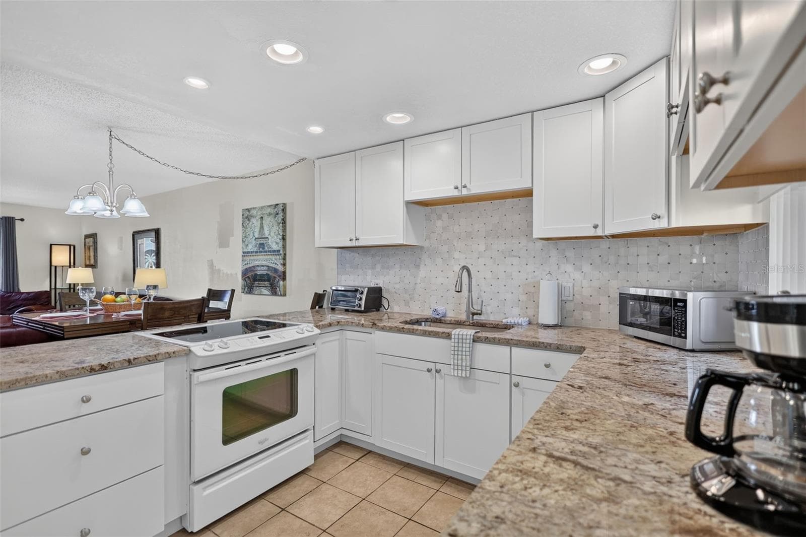 Fully equipped kitchen featuring modern appliances, ample counter space, and high-quality finishes. - 6157 MIDNIGHT PASS RD #E53, SARASOTA