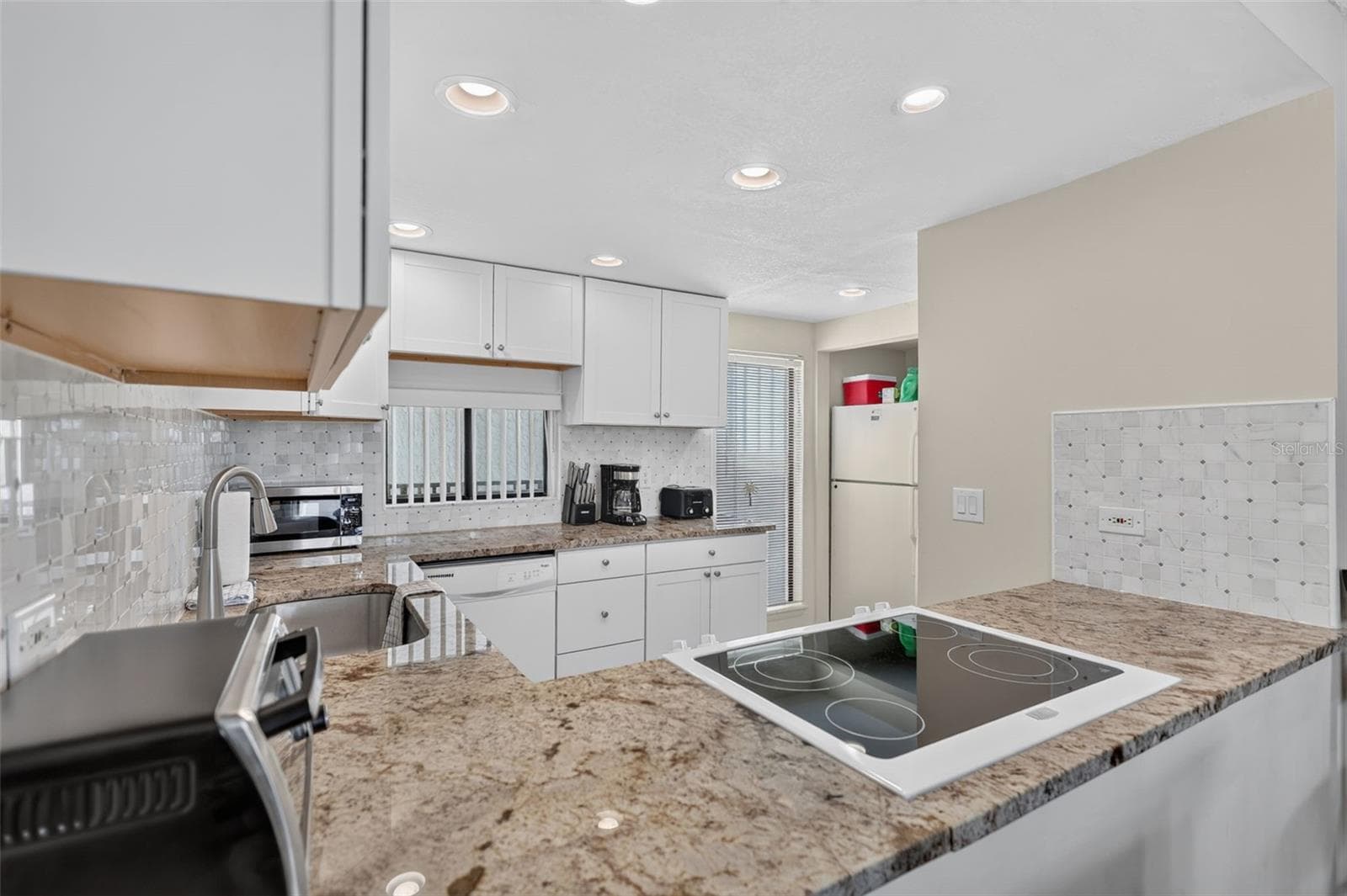 Thoughtfully designed kitchen layout optimized for functional ease and convenience. - 6157 MIDNIGHT PASS RD #E53, SARASOTA