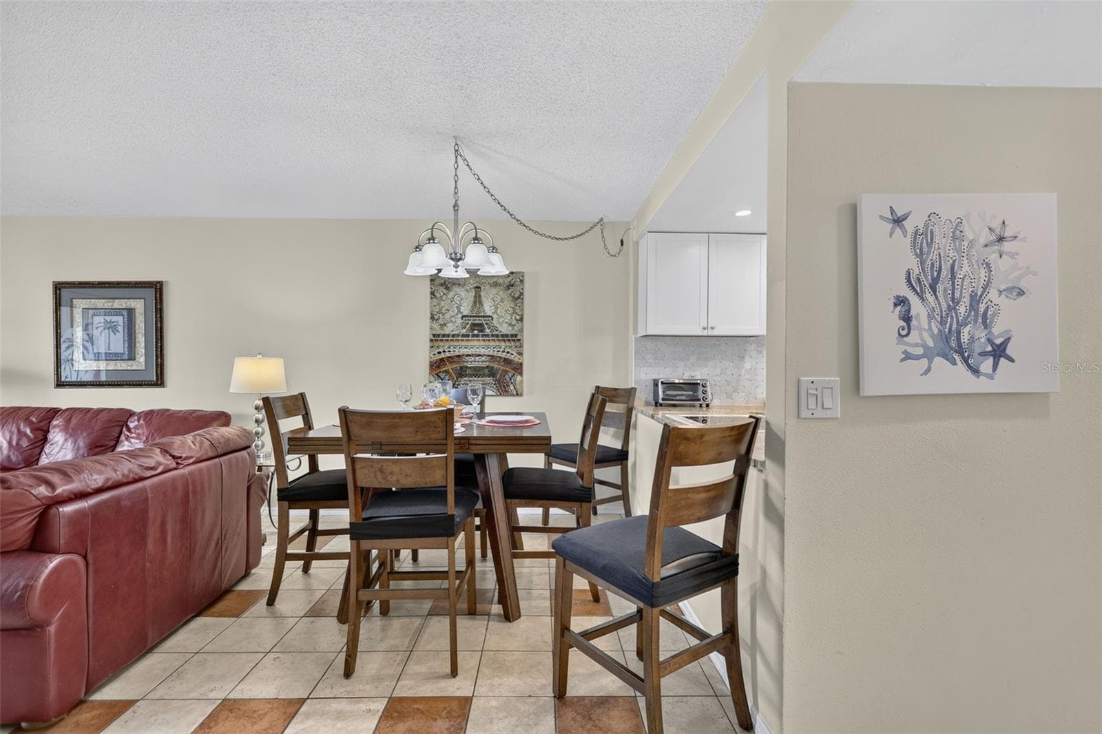 This dining area features a versatile table that expands to comfortably accommodate up to 8 guests. - 6157 MIDNIGHT PASS RD #E53, SARASOTA