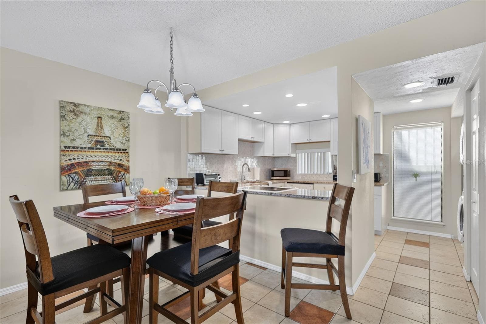 Open-concept kitchen and dining area featuring a seamless flow perfect for entertaining. - 6157 MIDNIGHT PASS RD #E53, SARASOTA