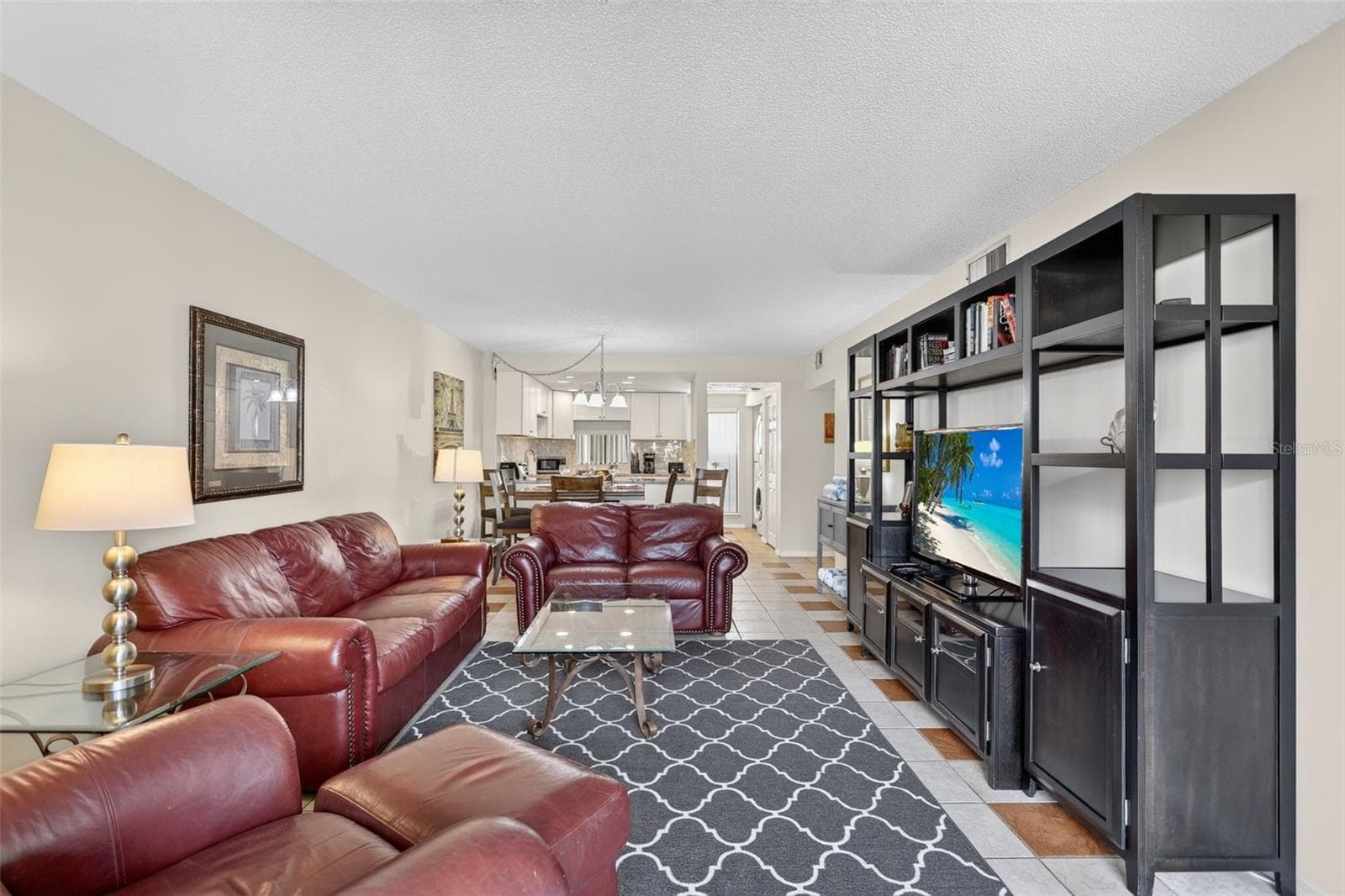 Beautifully renovated open-concept living room, dining area, and kitchen. - 6157 MIDNIGHT PASS RD #E53, SARASOTA