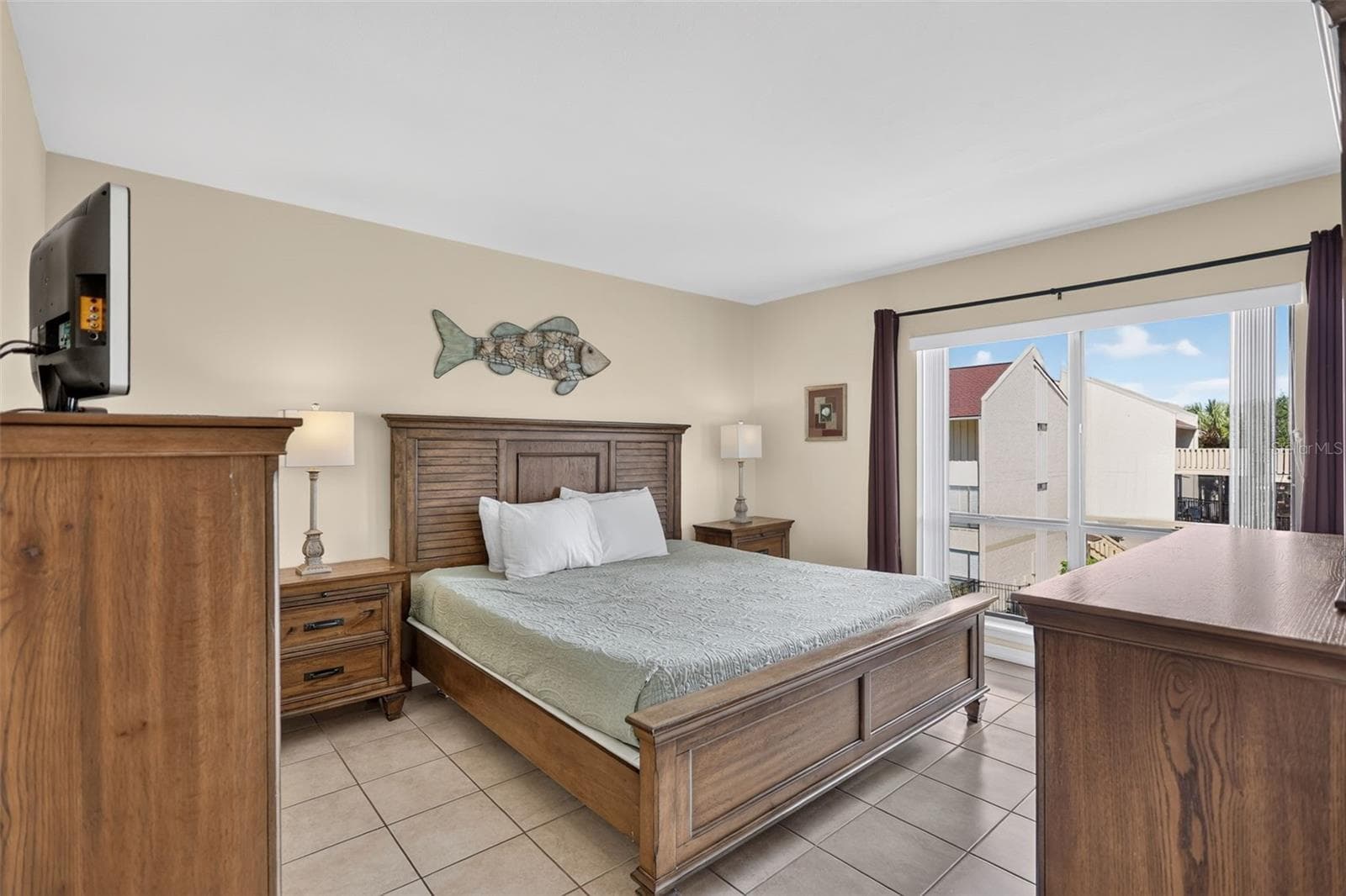 Spacious primary ensuite bedroom featuring a beautiful view of the pool. - 6157 MIDNIGHT PASS RD #E53, SARASOTA