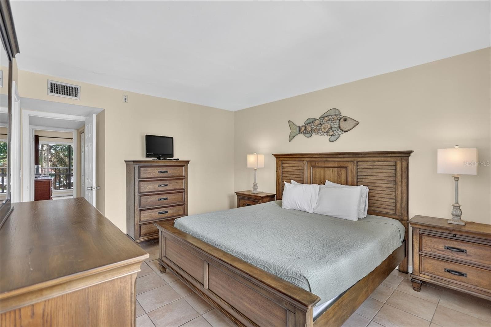Spacious primary bedroom featuring a generous layout and natural light. - 6157 MIDNIGHT PASS RD #E53, SARASOTA