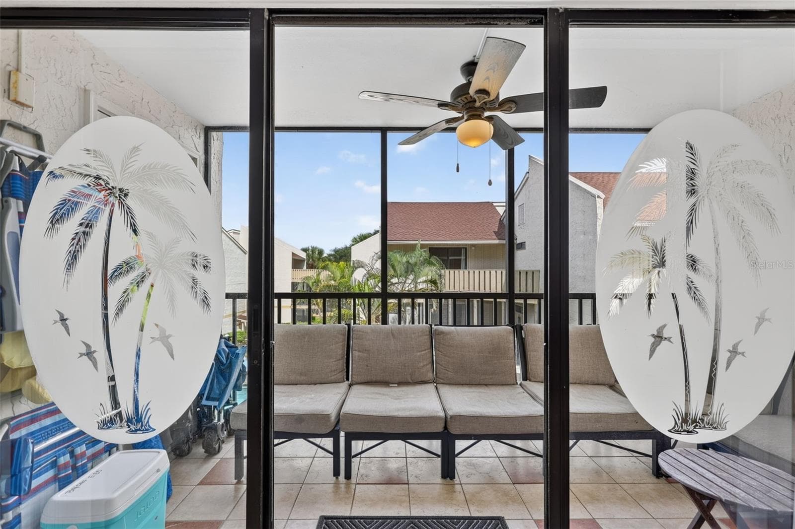 Sliding glass doors with etched detailing opening to a balcony with views overlooking the pool. - 6157 MIDNIGHT PASS RD #E53, SARASOTA
