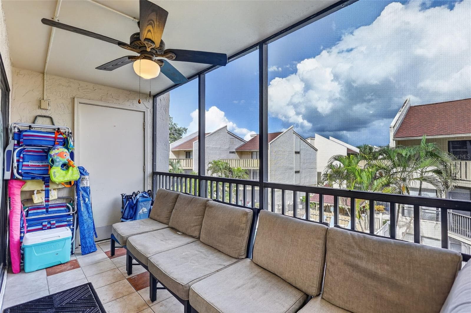 Spacious balcony featuring ample seating and dedicated storage space for the included beach toys. - 6157 MIDNIGHT PASS RD #E53, SARASOTA