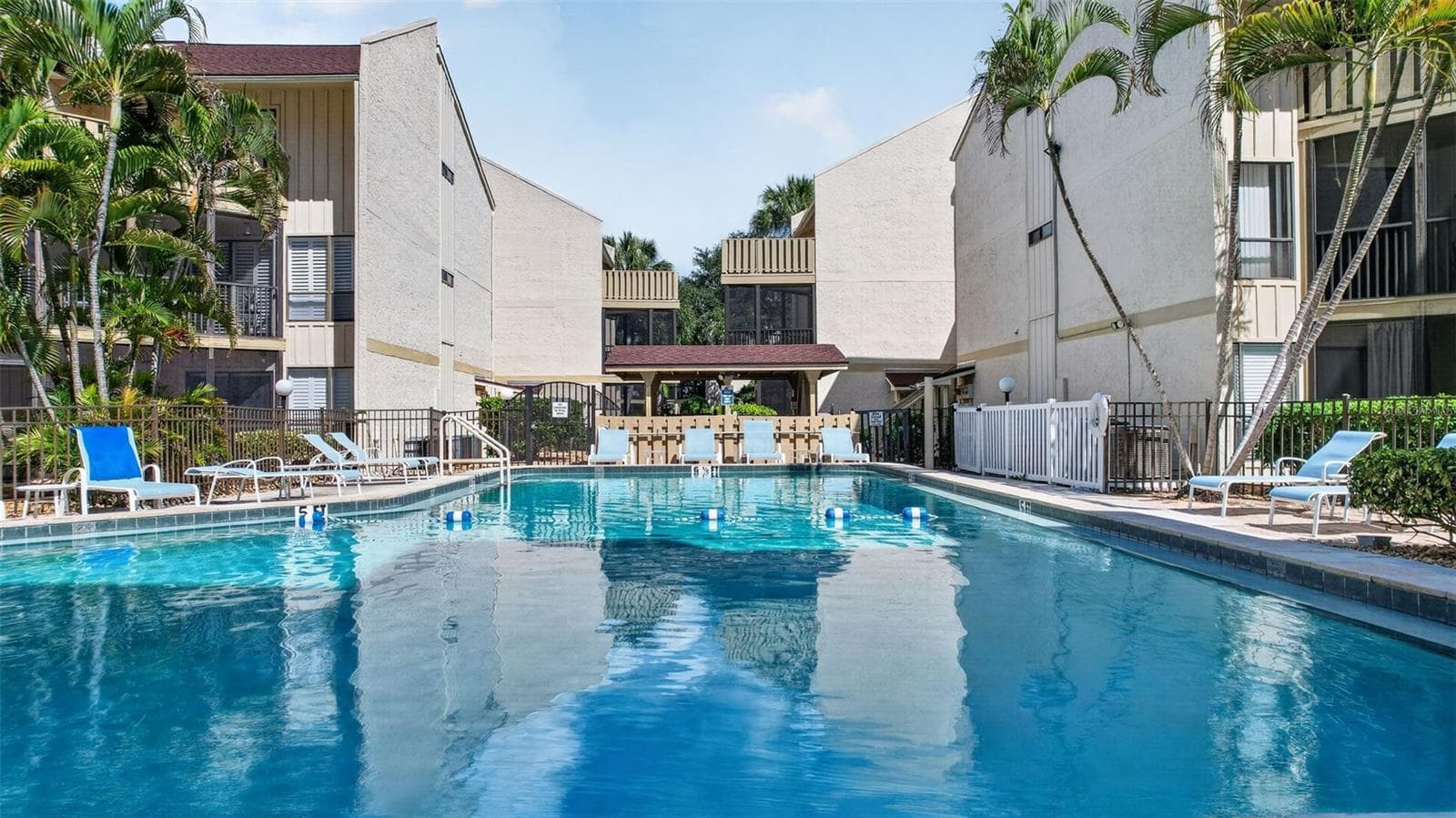 Stunning resort-style pool area, perfect for relaxing and entertaining. - 6157 MIDNIGHT PASS RD #E53, SARASOTA