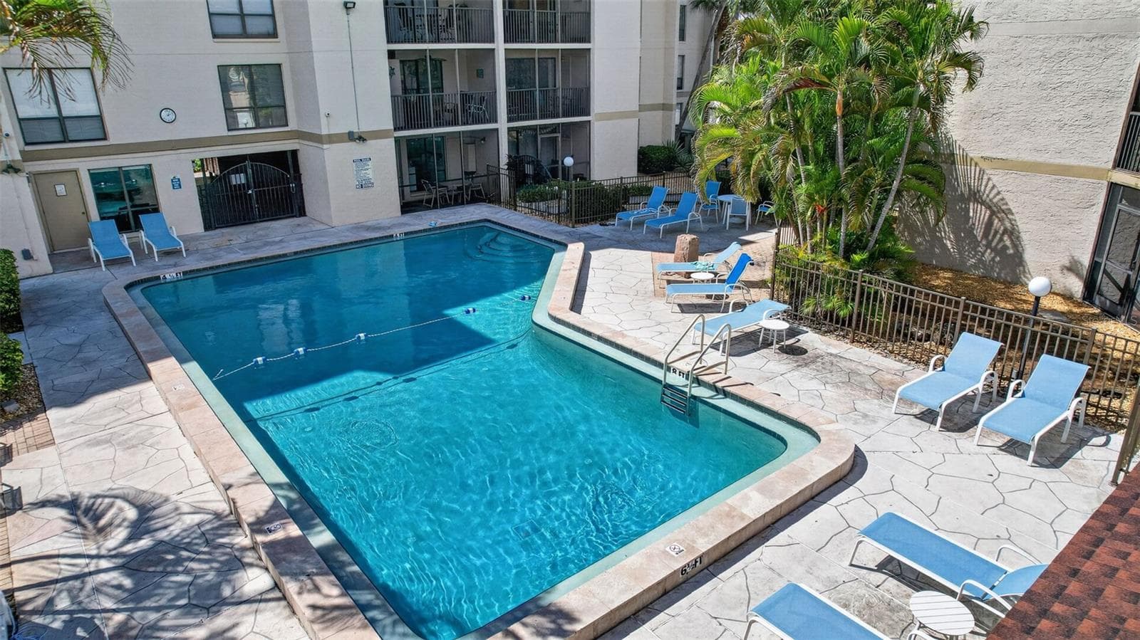 Plenty of lounge chairs surrounding the pool, perfect for soaking in the sun. - 6157 MIDNIGHT PASS RD #E53, SARASOTA
