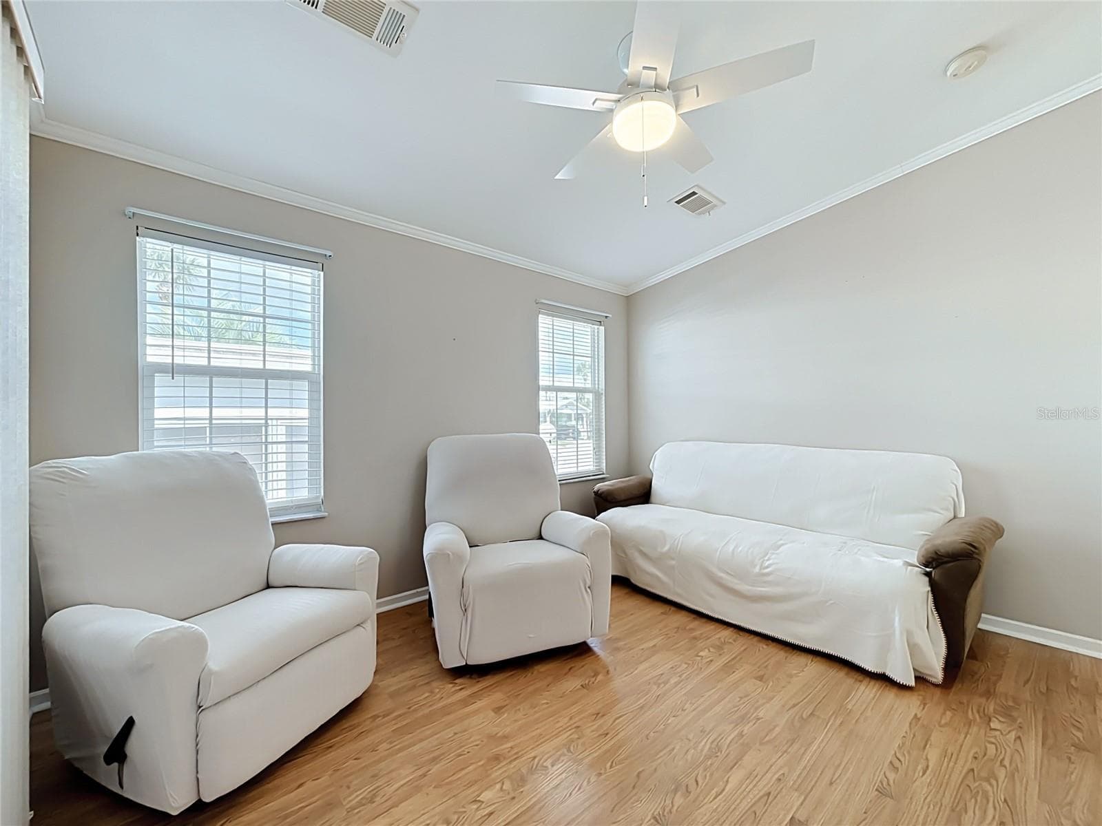 Living room provides easy access to elevated screen room with vinyl windows overlooking and providing access to the rear deck - 9000 US HIGHWAY 192 #181, CLERMONT