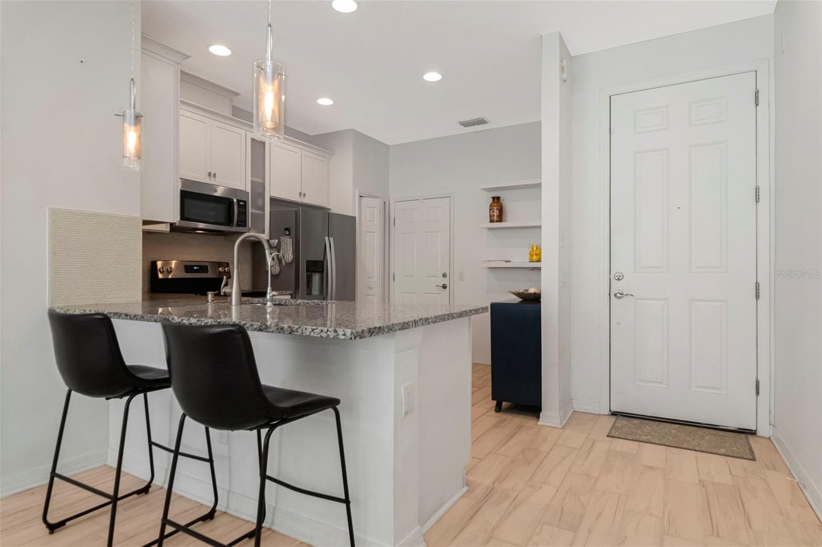 A welcoming entryway featuring a stylish breakfast bar. - 2455 GOLDEN PASTURE CIR, CLEARWATER