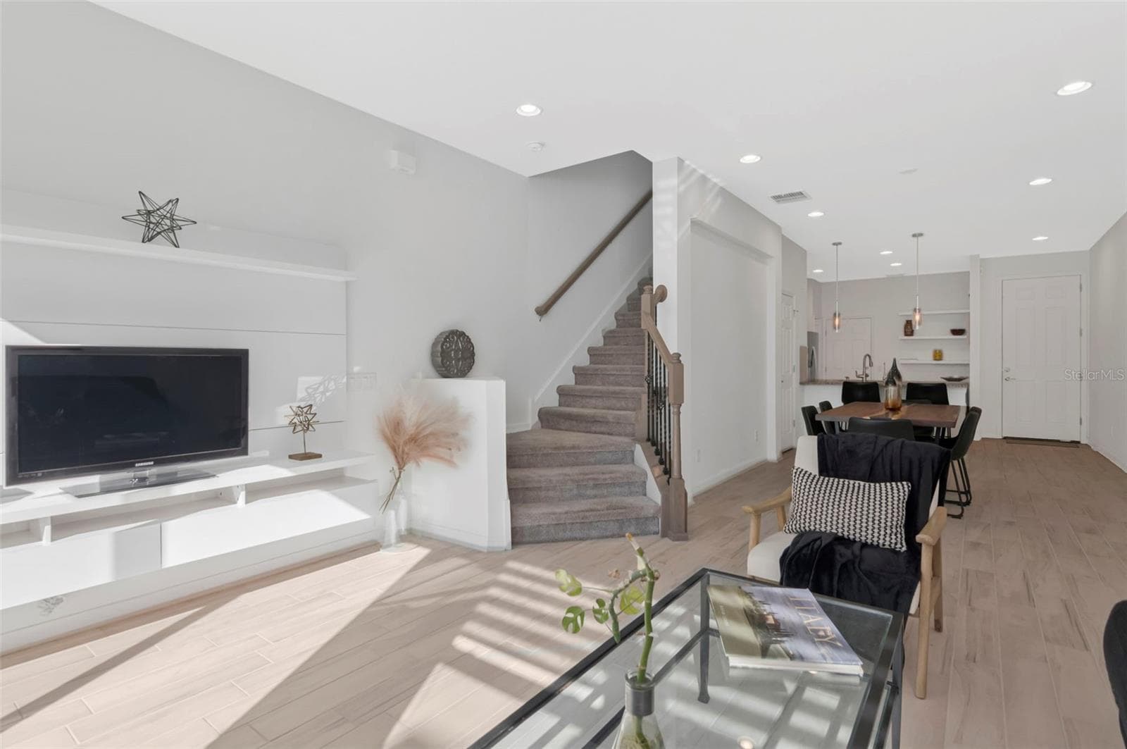 Spacious living area filled with natural light, featuring a staircase leading to the second floor. - 2455 GOLDEN PASTURE CIR, CLEARWATER