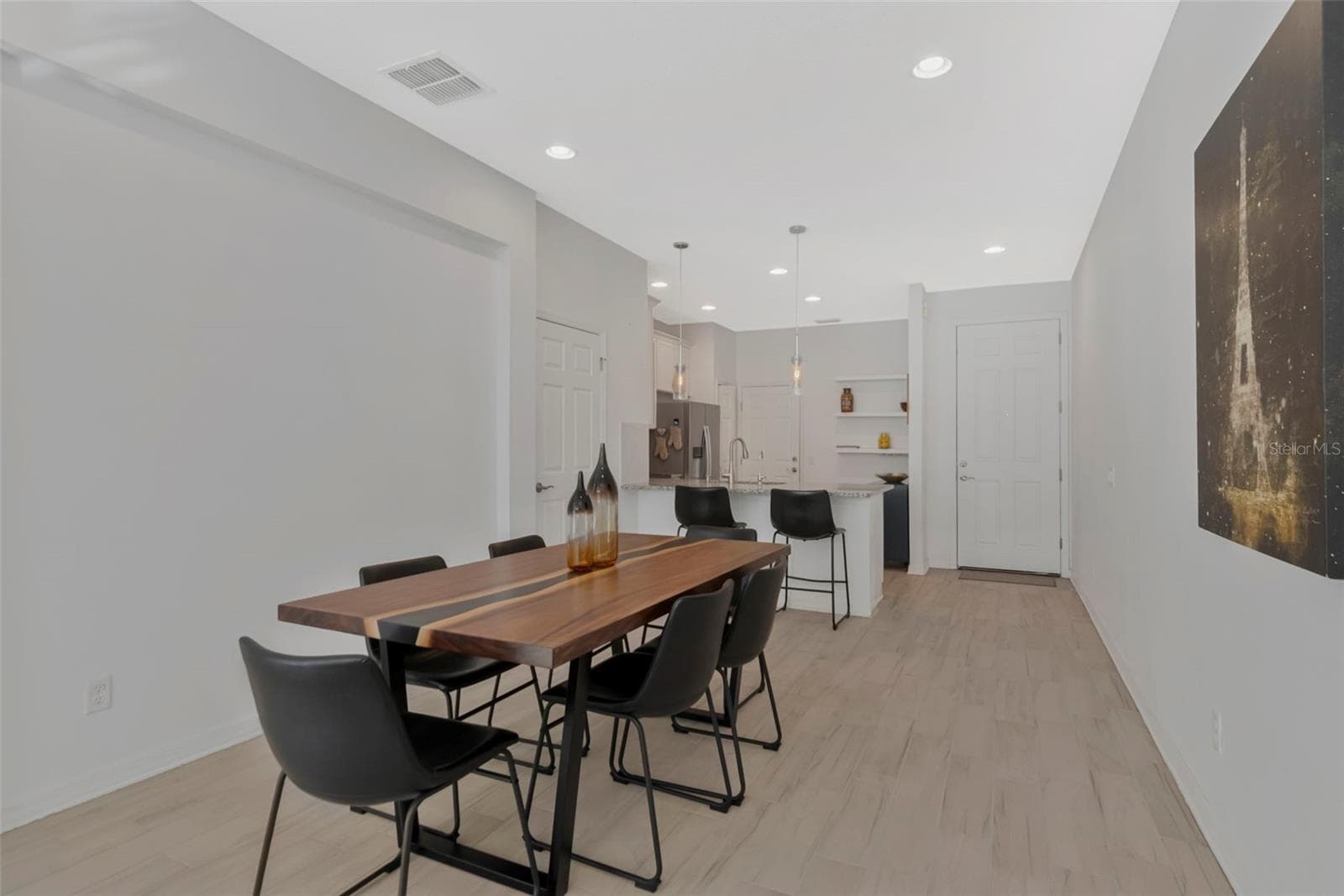 Charming breakfast and dining area with crisp white walls and elegant tile flooring. - 2455 GOLDEN PASTURE CIR, CLEARWATER