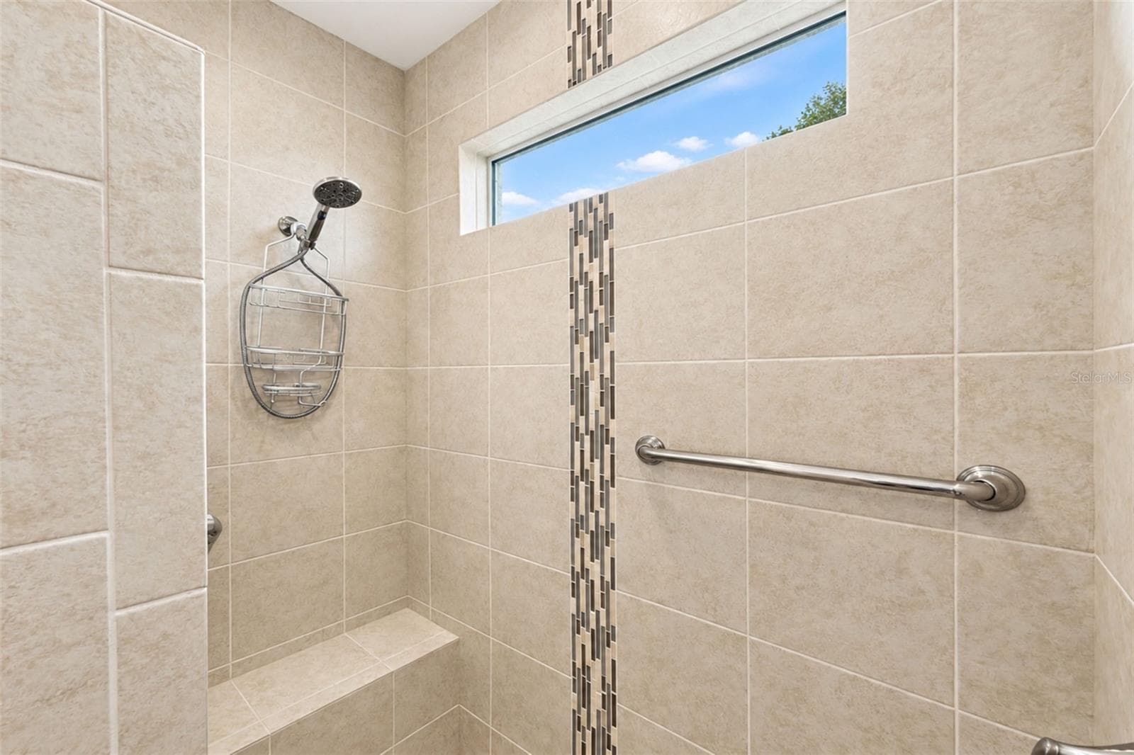 Fully tiled, floor-to-ceiling, with grab bar and bench seat - 2181 WAKEFIELD ST, PORT CHARLOTTE