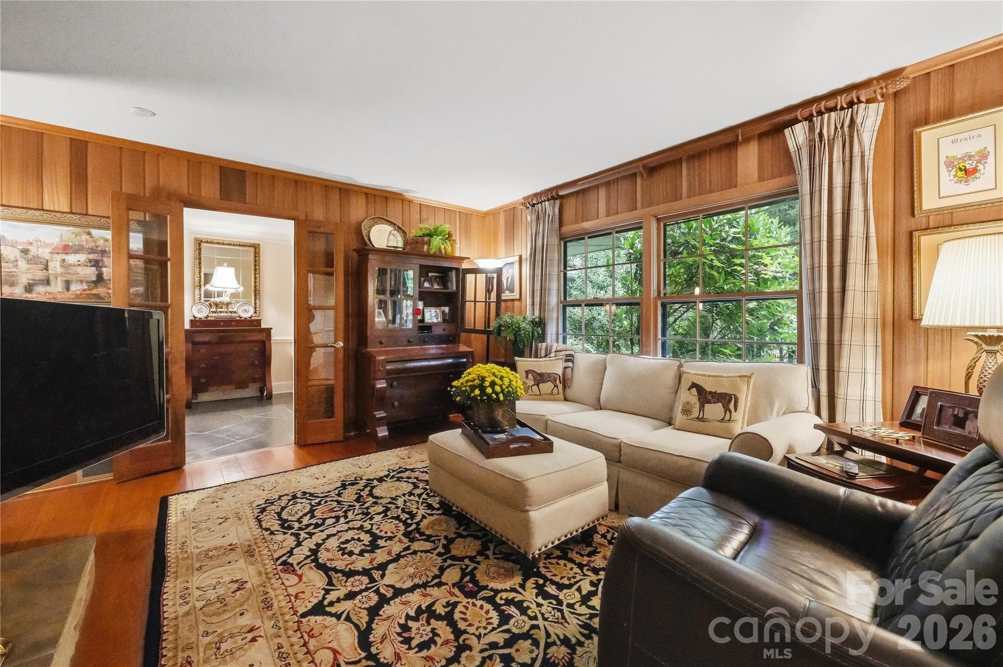 living room with wood panel walls - 7600 Park Road, Charlotte