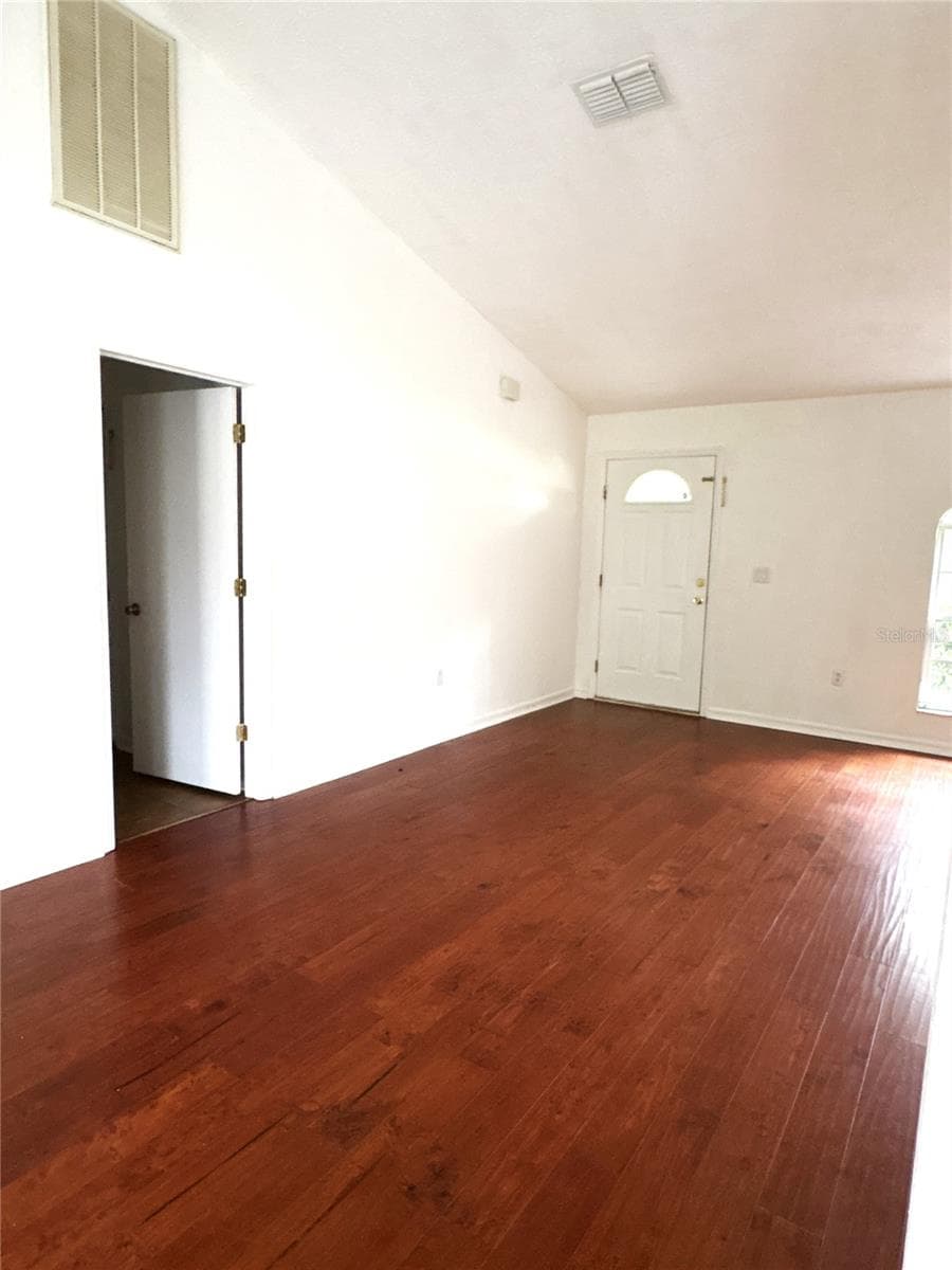 Looking at front door from dining area.  Laundry room with access to the garage is the open doorway. - 8919 N MENDOZA WAY, CITRUS SPRINGS
