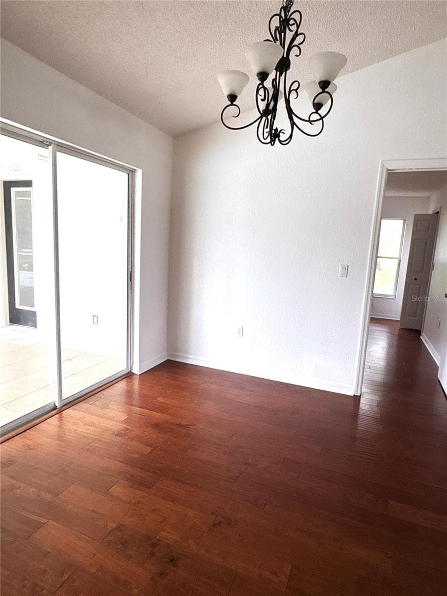 From kitchen looking across dining area to primary bedroom entrance. - 8919 N MENDOZA WAY, CITRUS SPRINGS