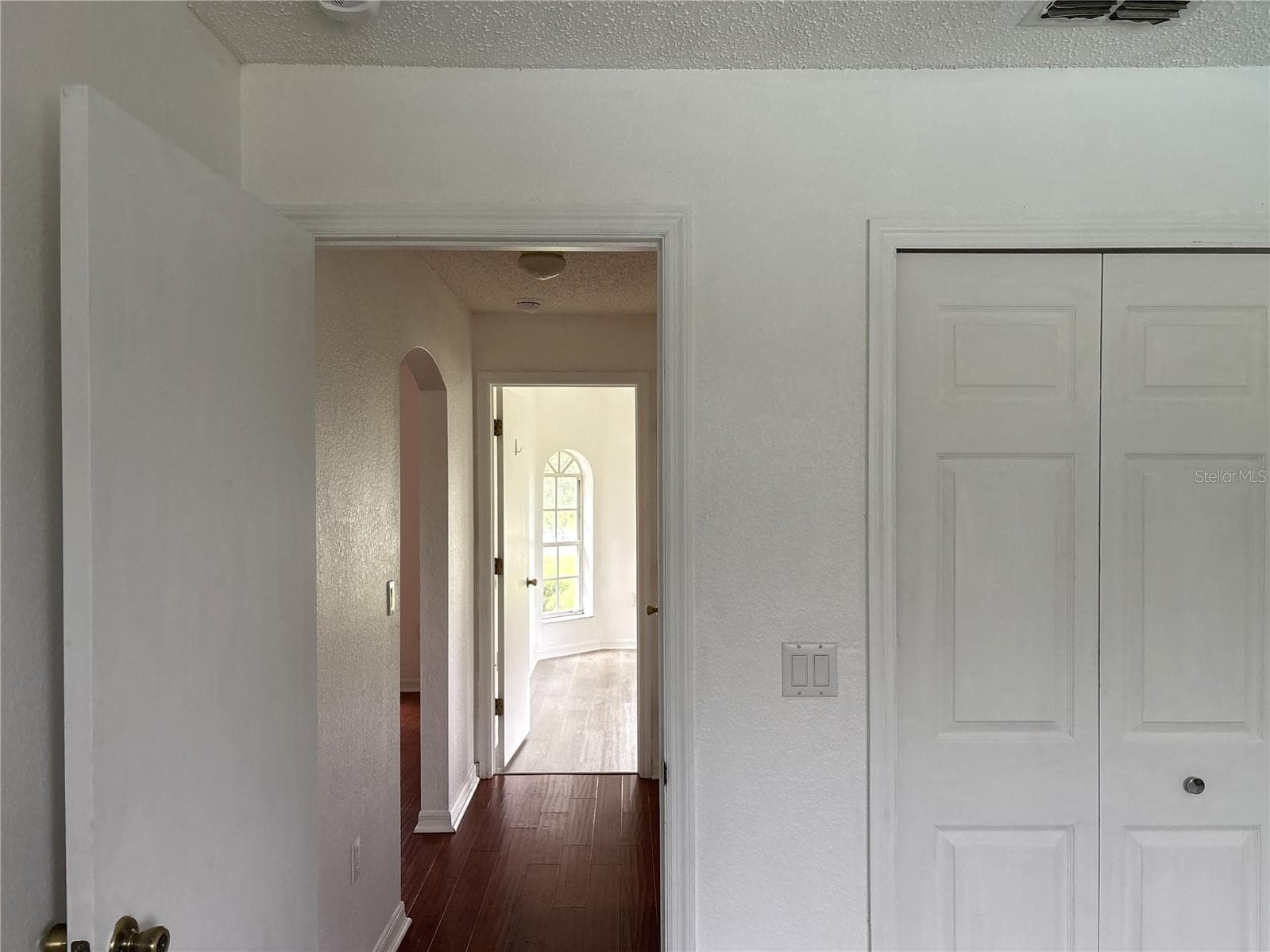 From second bedroom looking down hallway toward guest bath and first guest bedroom - 8919 N MENDOZA WAY, CITRUS SPRINGS