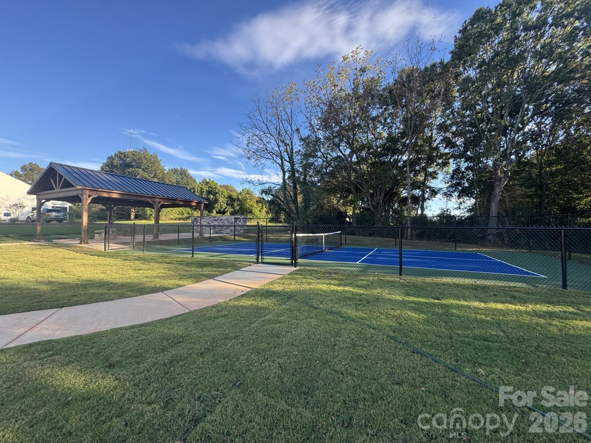 Pavillion, pickleball and outdoor seating area with a gas fireplace - 209 Rodeo Drive, Shelby