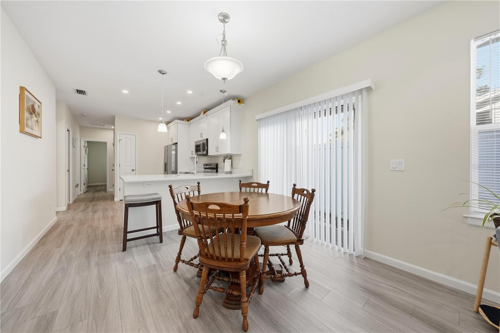 Dining area with sliding doors to the side yard - 1911 VIRGINIA AVE, EUSTIS