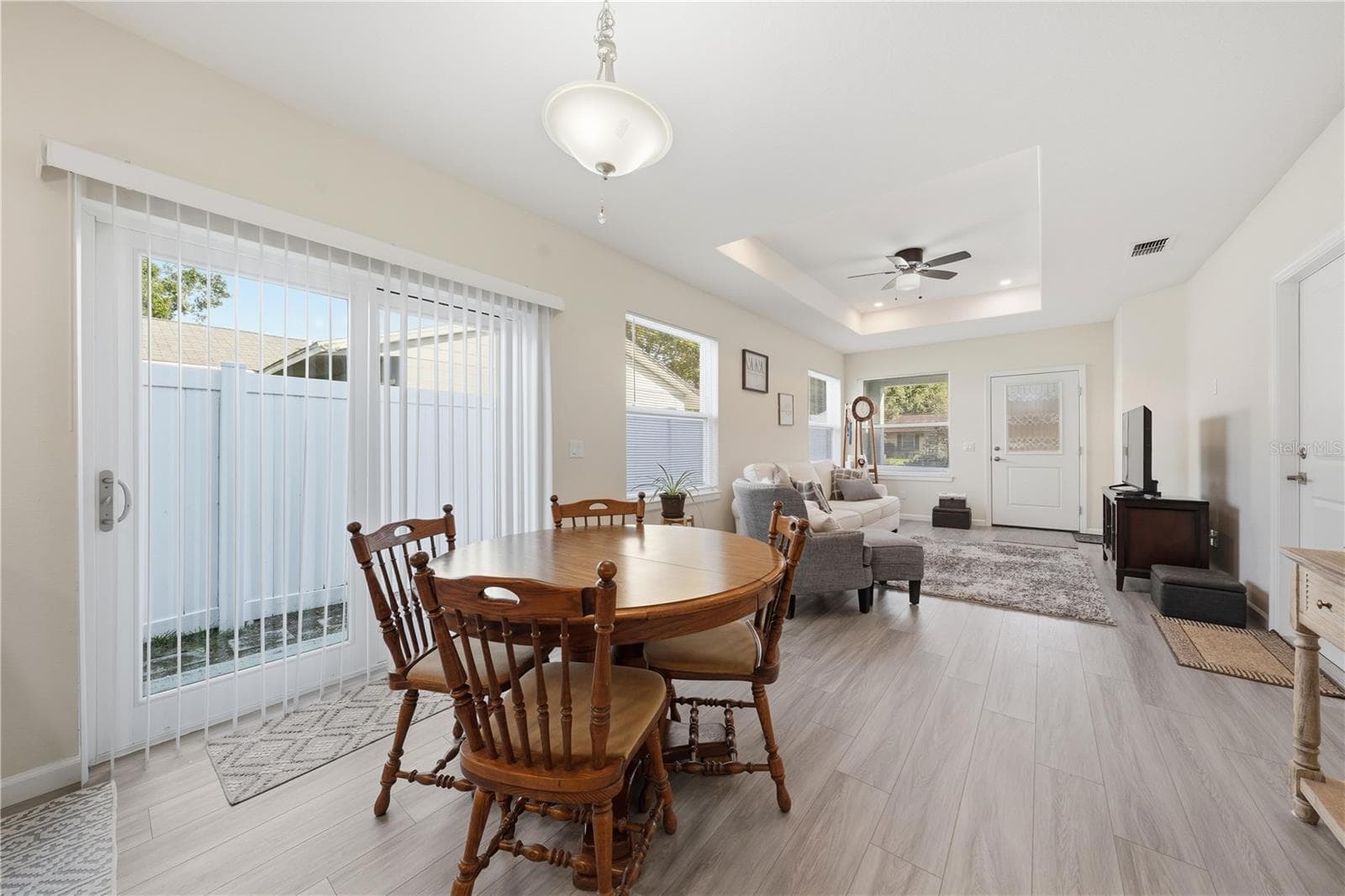 dining area and great room with sliding doors to the side yard - 1911 VIRGINIA AVE, EUSTIS
