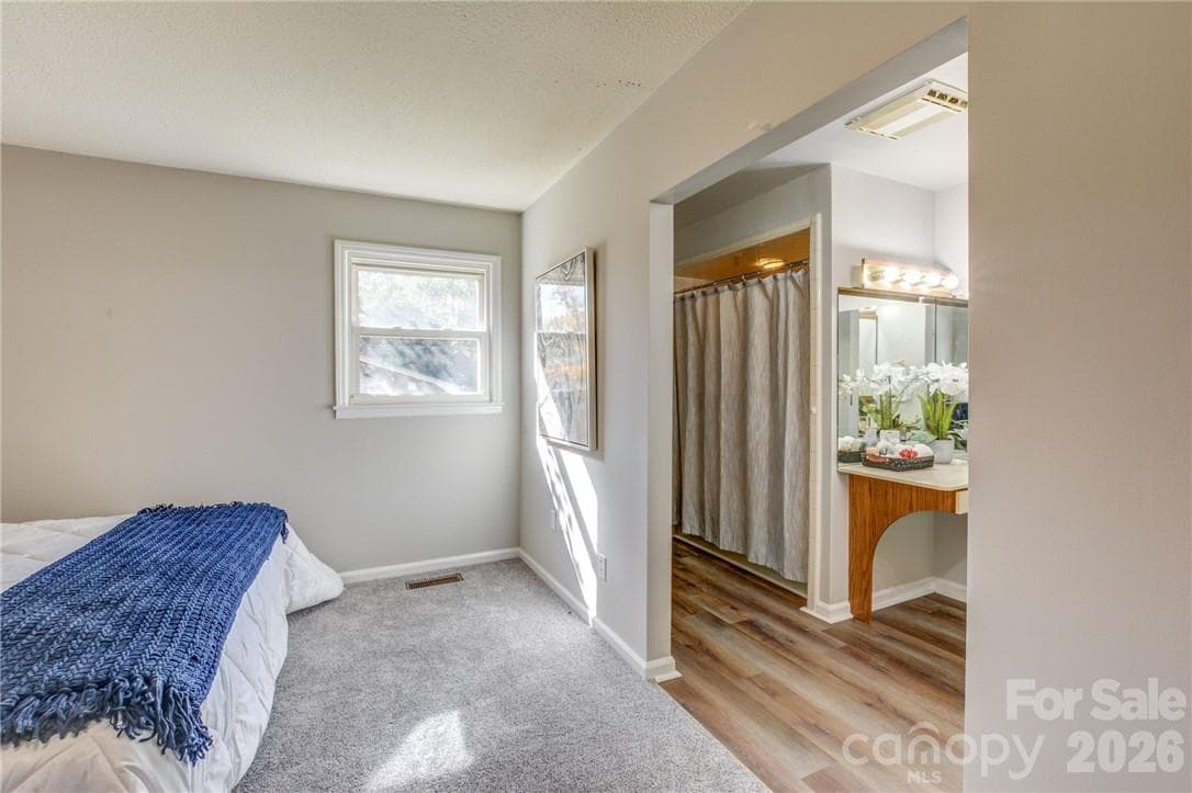 Primary bedroom opens to bathroom with tub and separate shower - 311 Bell Road, Kings Mountain