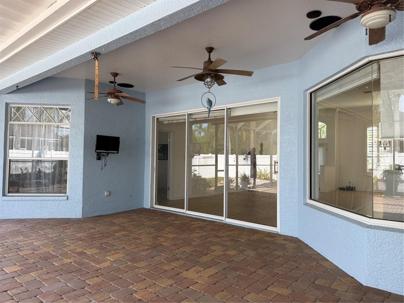 Patio Covered lanai with two ceiling fans and a TV. - 2311 OASIS DR, LAND O LAKES