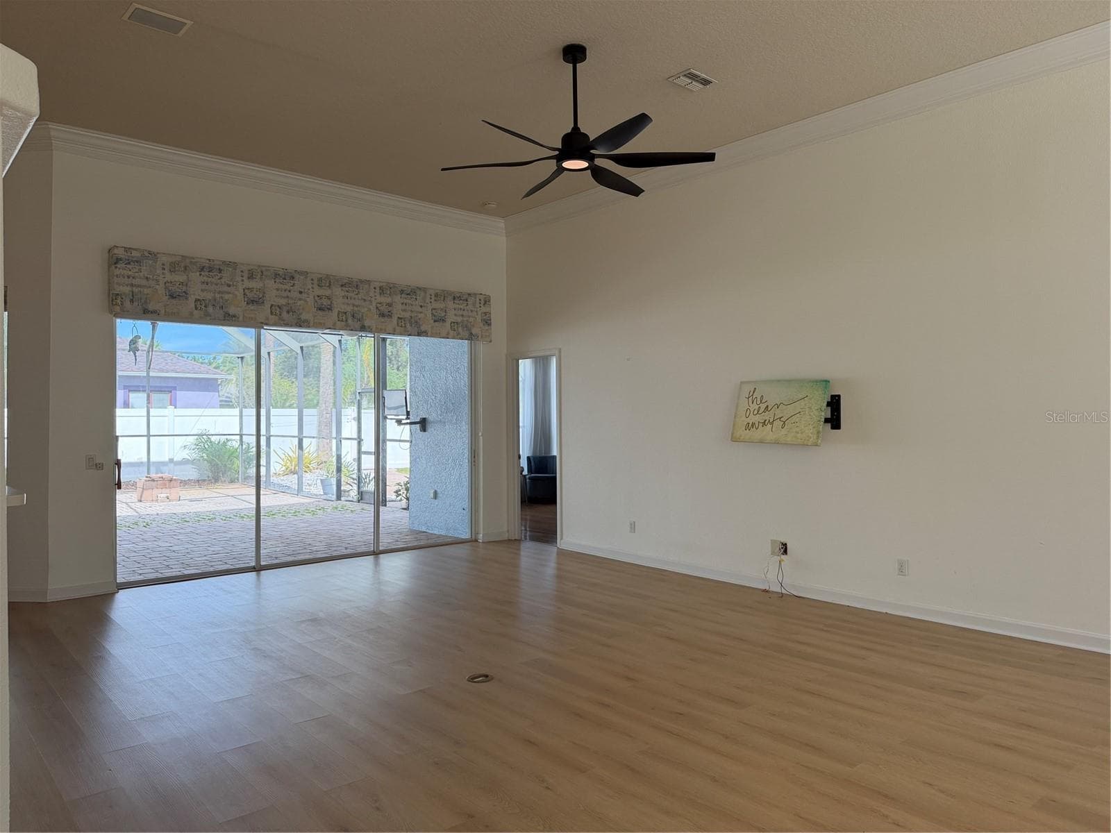 The picture on the wall is hiding the bracket mount for a flat screen TV - 2311 OASIS DR, LAND O LAKES
