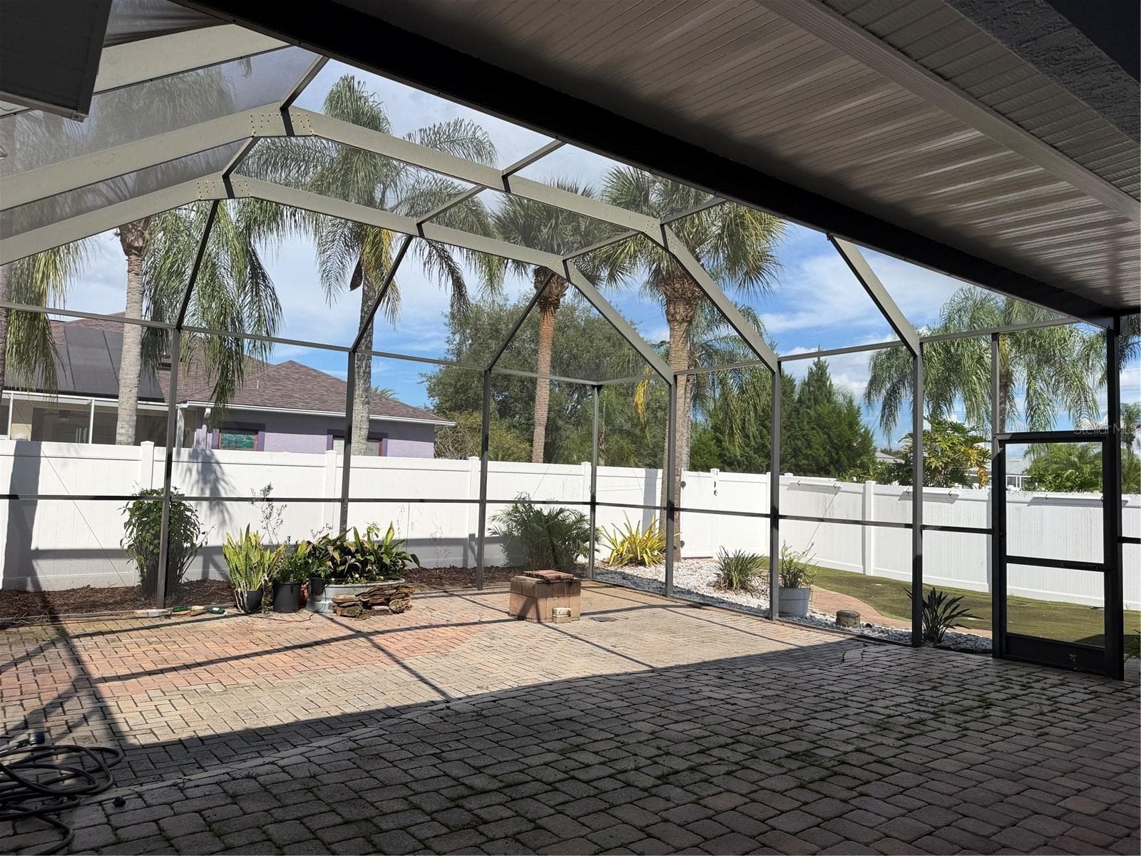 Screened lanai has exits into the backyard from both sides. - 2311 OASIS DR, LAND O LAKES