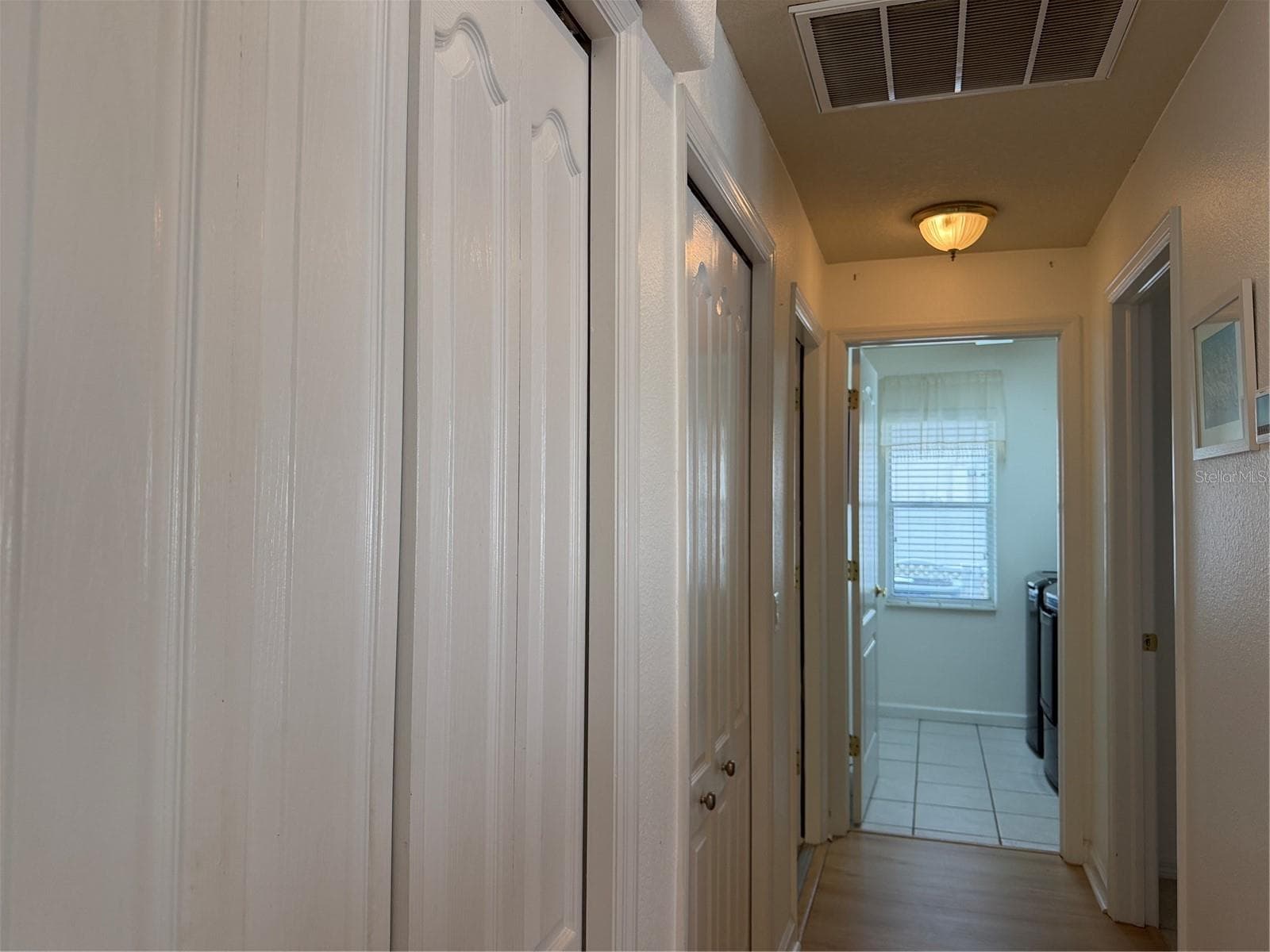 Beyond closets to the left is a door that enters bonus room and garage. Straight ahead is indoor laundry room. Door to right leads to 2nd bedroom - 2311 OASIS DR, LAND O LAKES